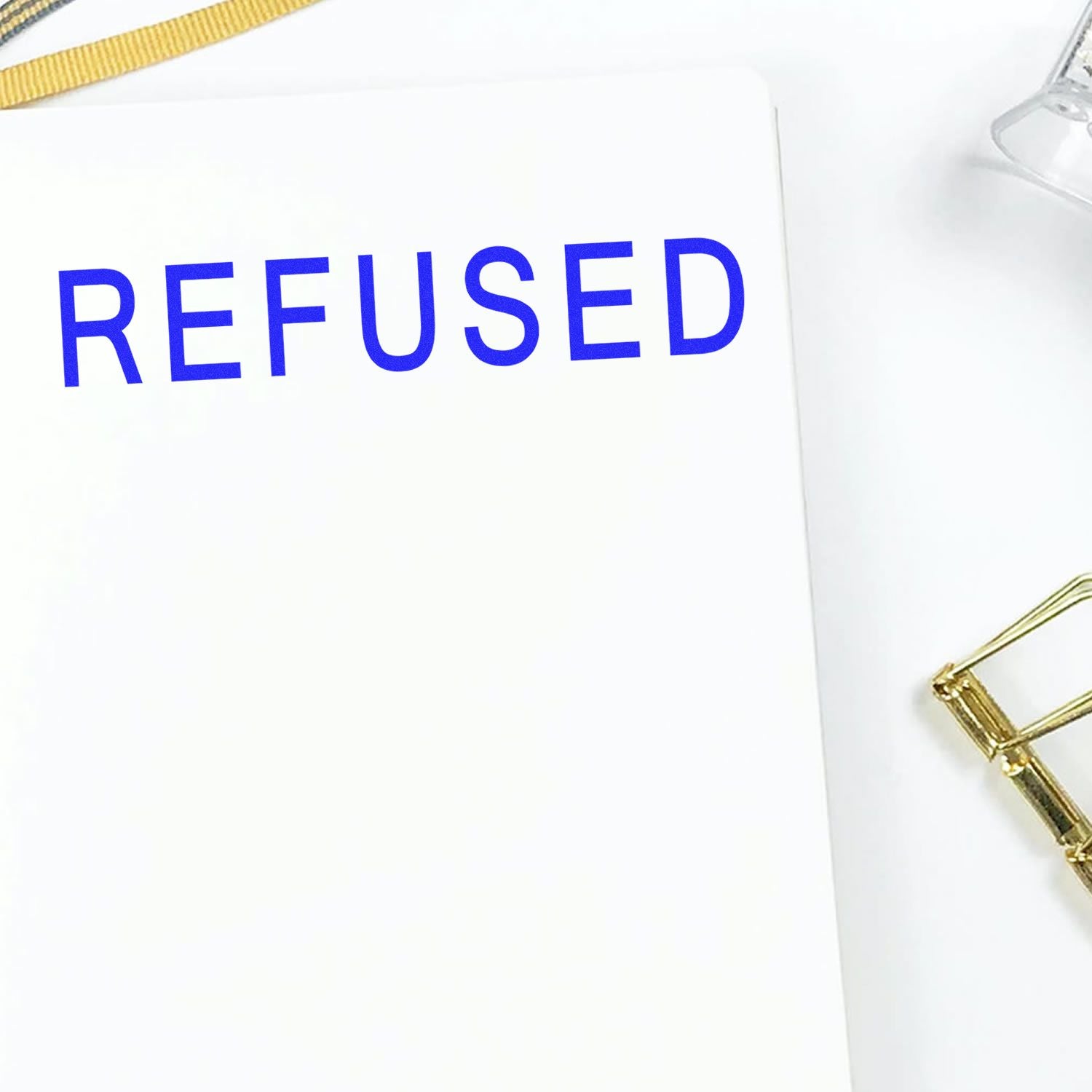 REFUSED document folder with bold blue text and gold zipper, representing denied claims or rejected applications.