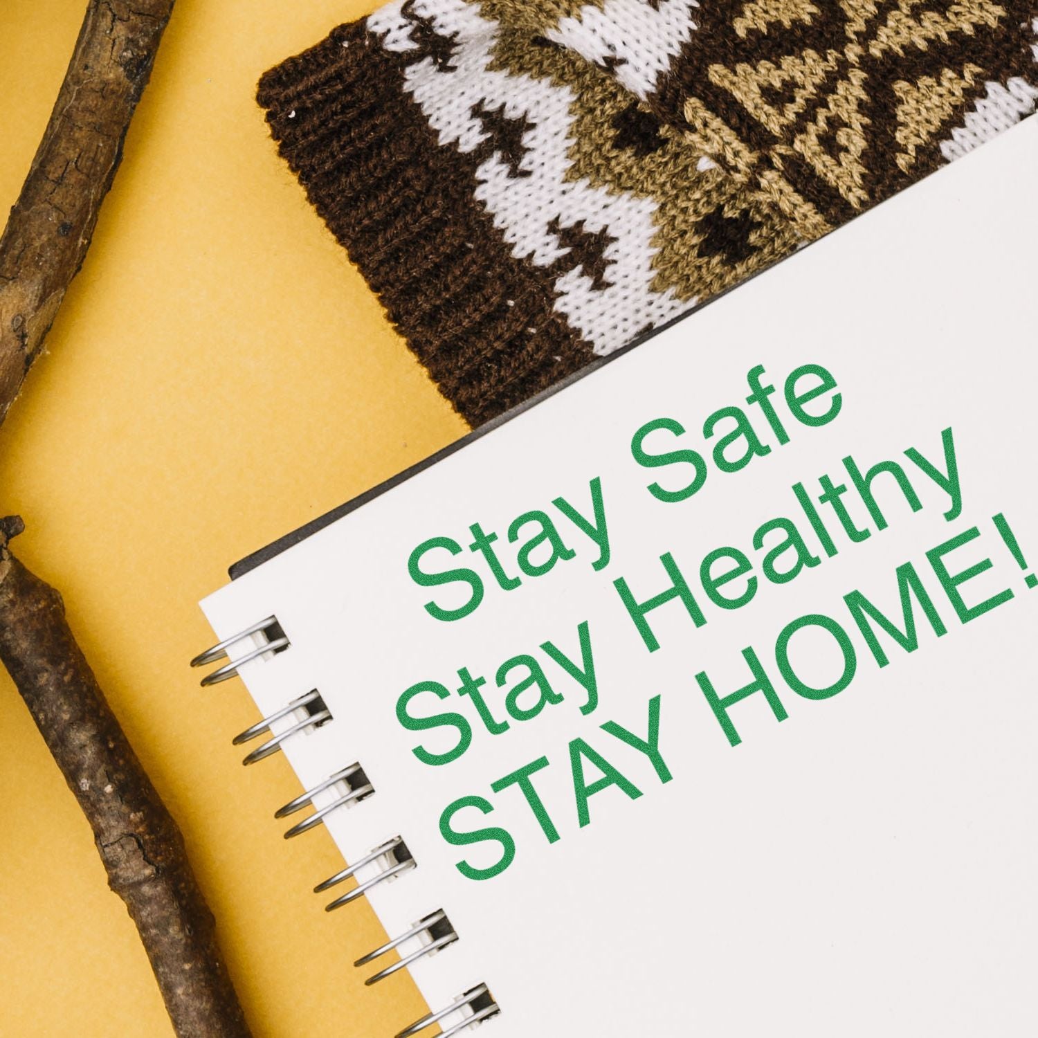Stay Safe Stay Healthy message on a journal notebook cover with knitted fabric detail for health awareness.