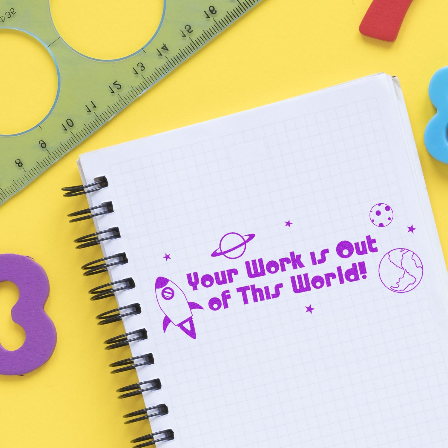 Space-themed notebook page with motivational quote Your work is out of this world! on yellow school supplies, ruler background