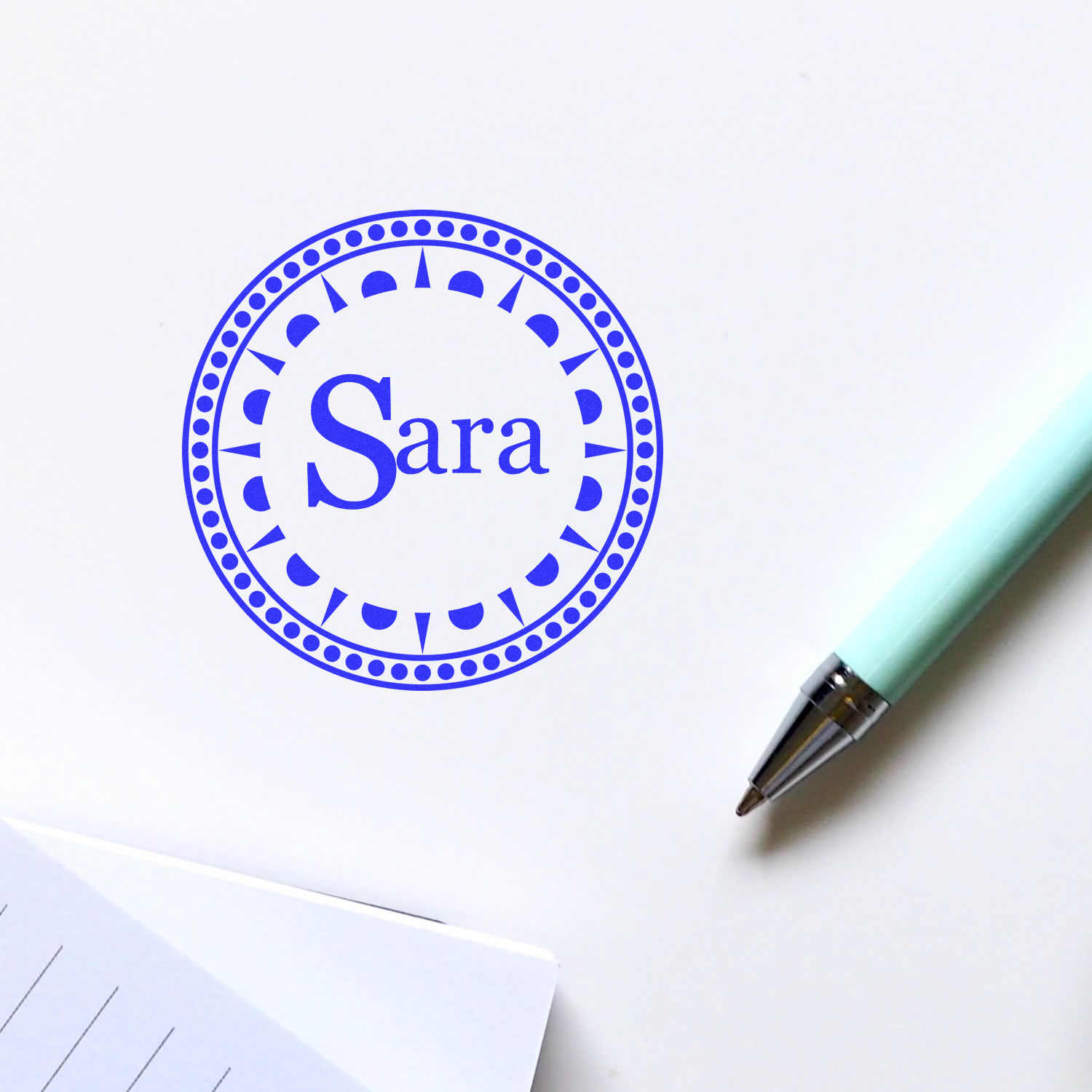 Custom Sara rubber stamp with decorative circular seal design for personalized stationery, cards, and branding.