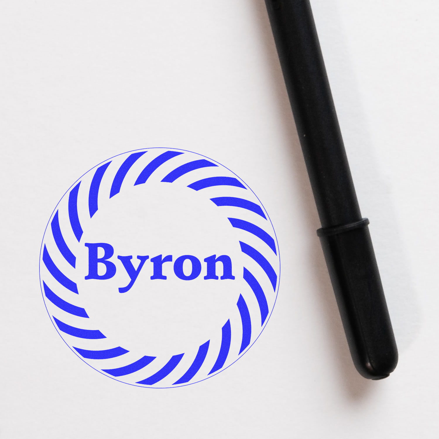 Personalized rubber stamp with Byron name and circular logo design for custom branding.