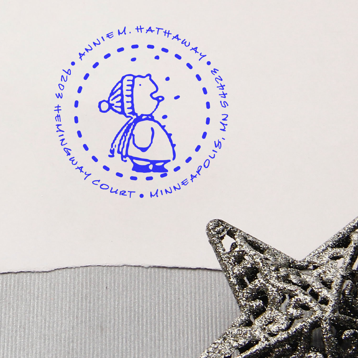 Blue custom rubber stamp impression of a circular court seal with Annie M. Hathaway, Minneapolis, MN 55473.