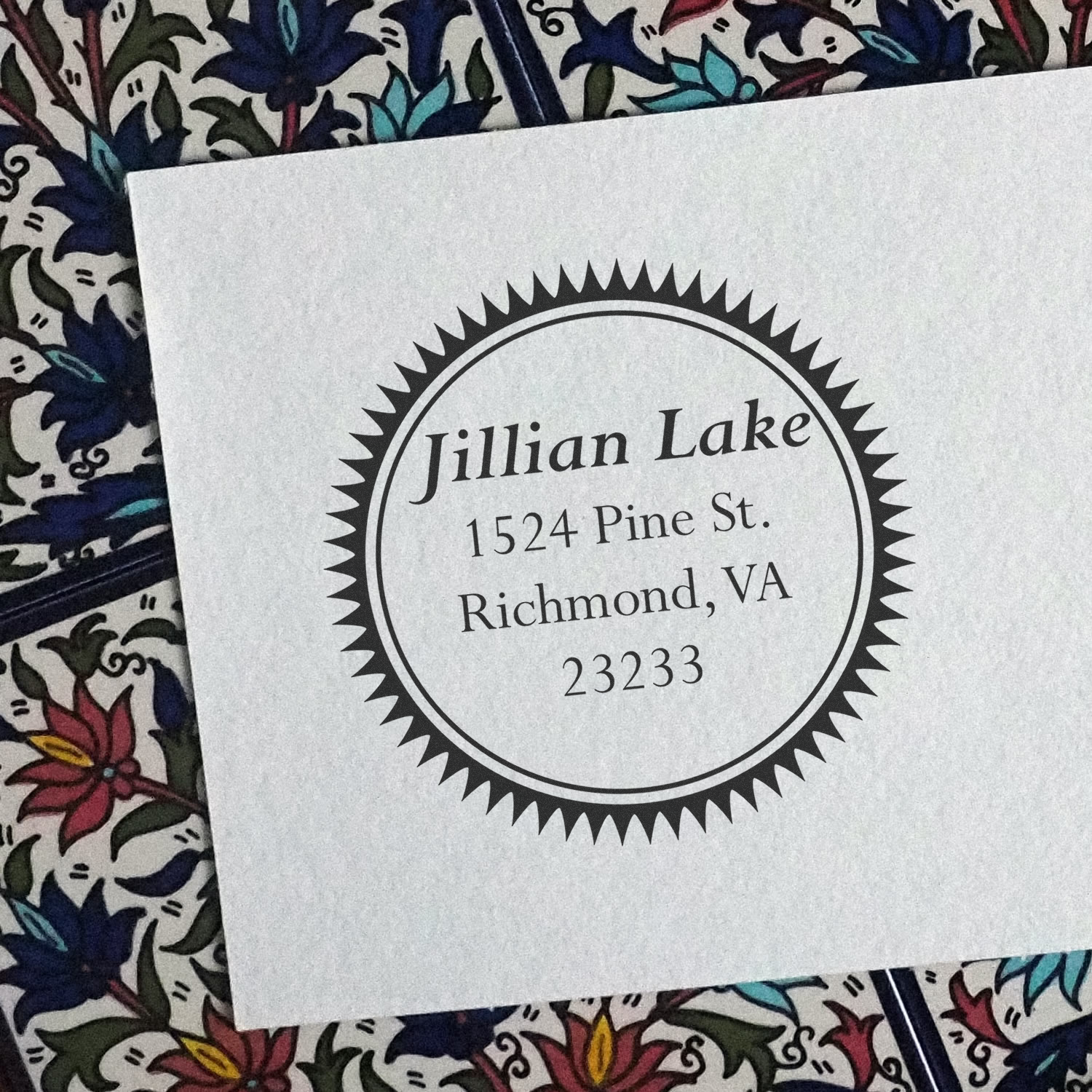 Custom return address rubber stamp with circular sunburst design for Jillian Lake, 1524 Pine St., Richmond, VA 23233.