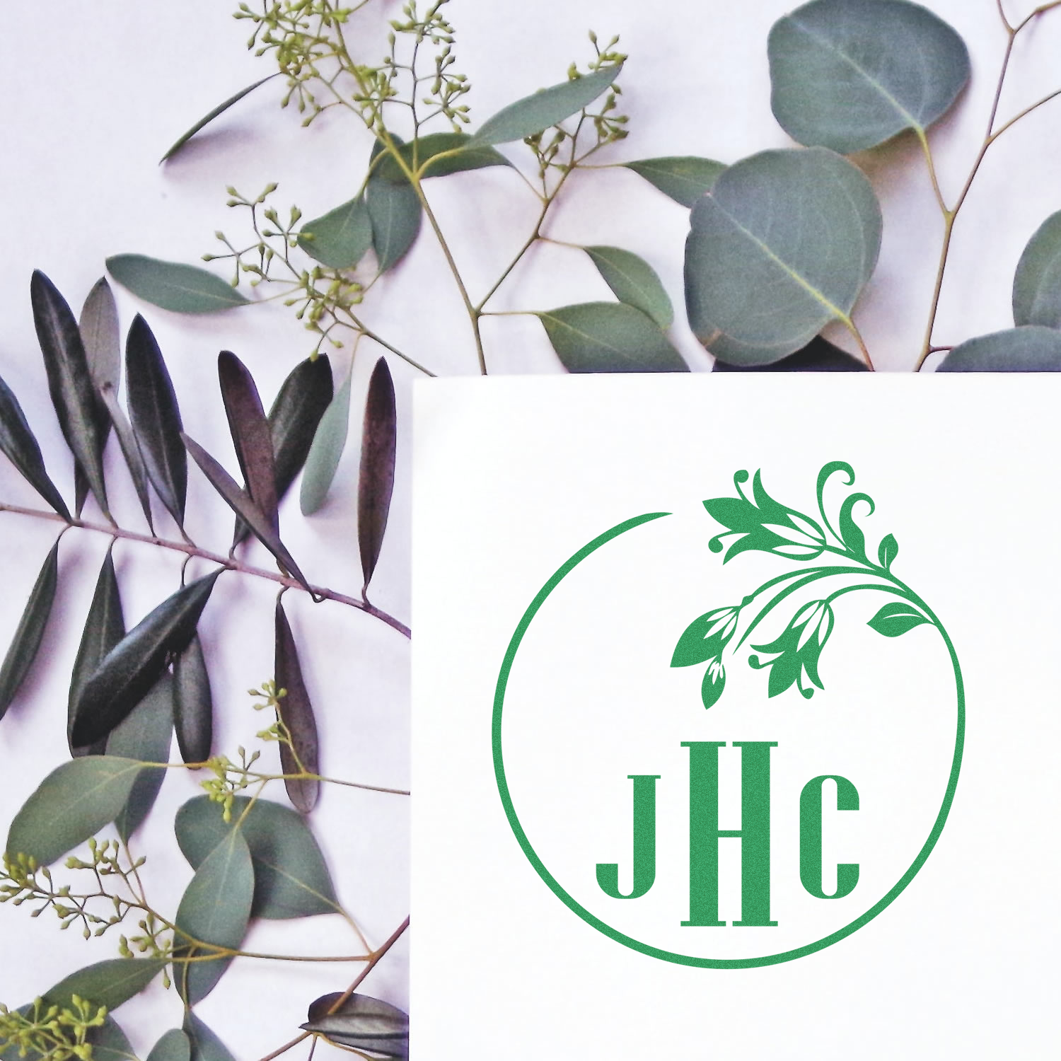 Custom botanical monogram rubber stamp with eucalyptus wreath and JHC initials for wedding stationery, branding, or favors.