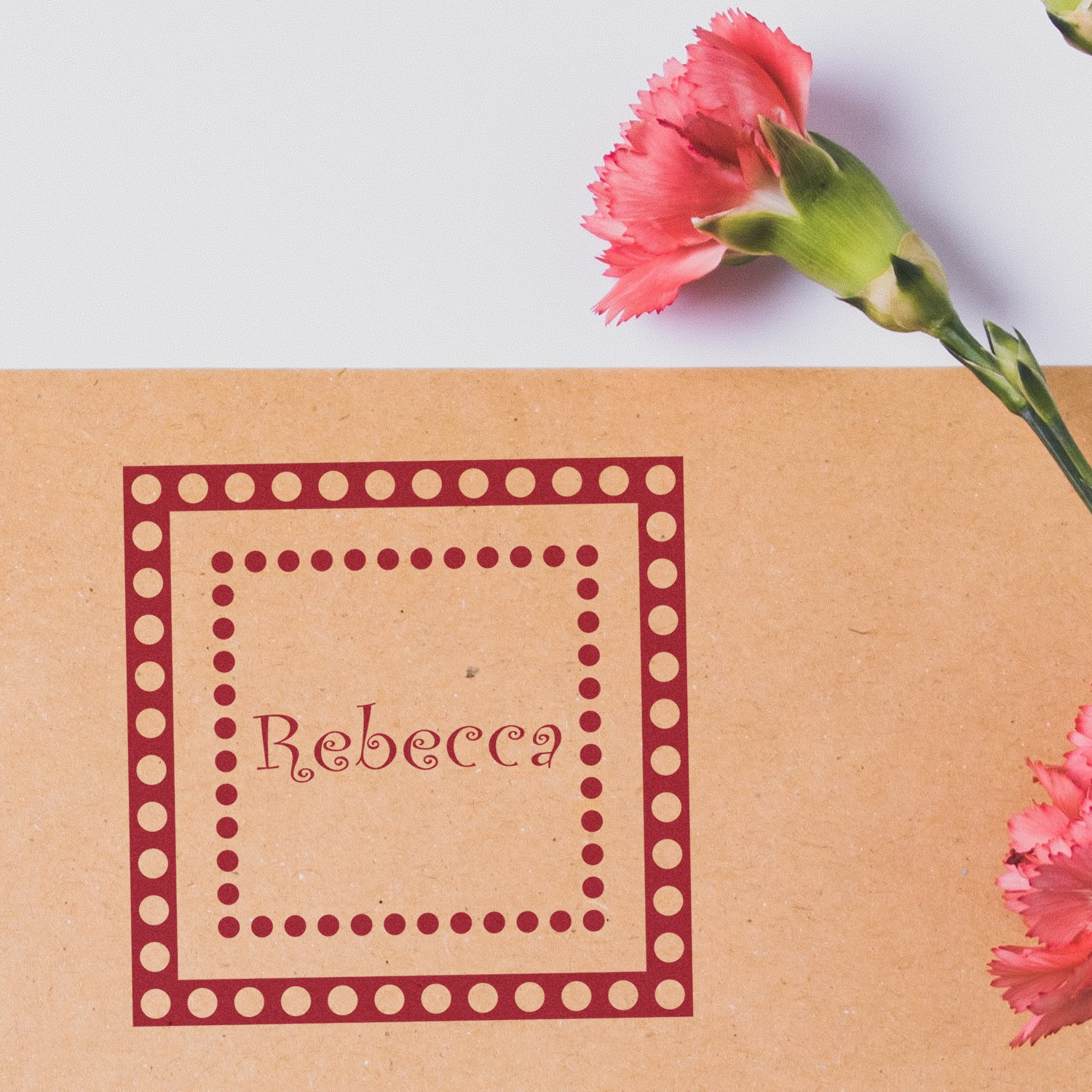 Custom Rebecca rubber stamp with dotted square border, ideal for personalized stationery, gift tags, and craft packaging.