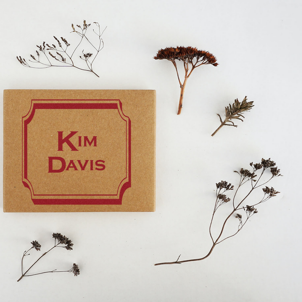 Custom Kim Davis rubber stamp on kraft box, perfect for personalized branding, packaging, or stationery.