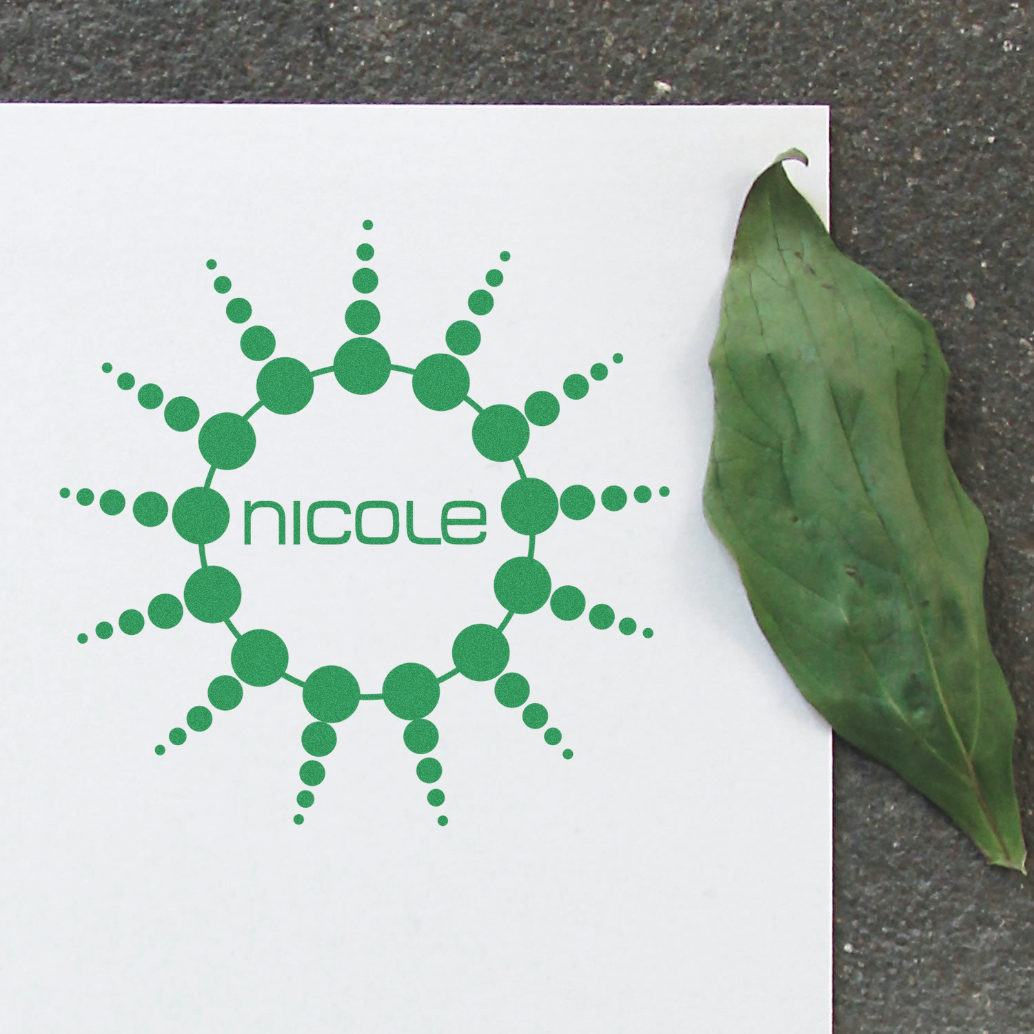 Nicole brand label with green dot molecular network and leaf on white card, promoting eco-friendly natural wellness product packaging