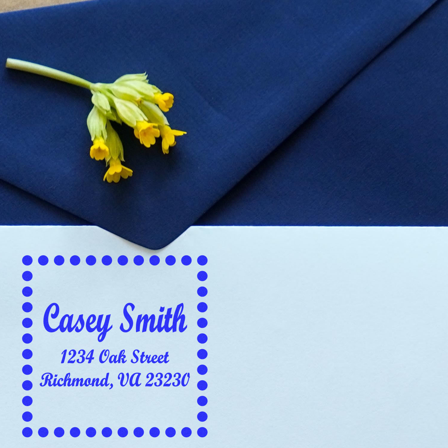 Custom rubber address stamp with dotted border on envelope, showing Casey Smith, Richmond, VA 23230.