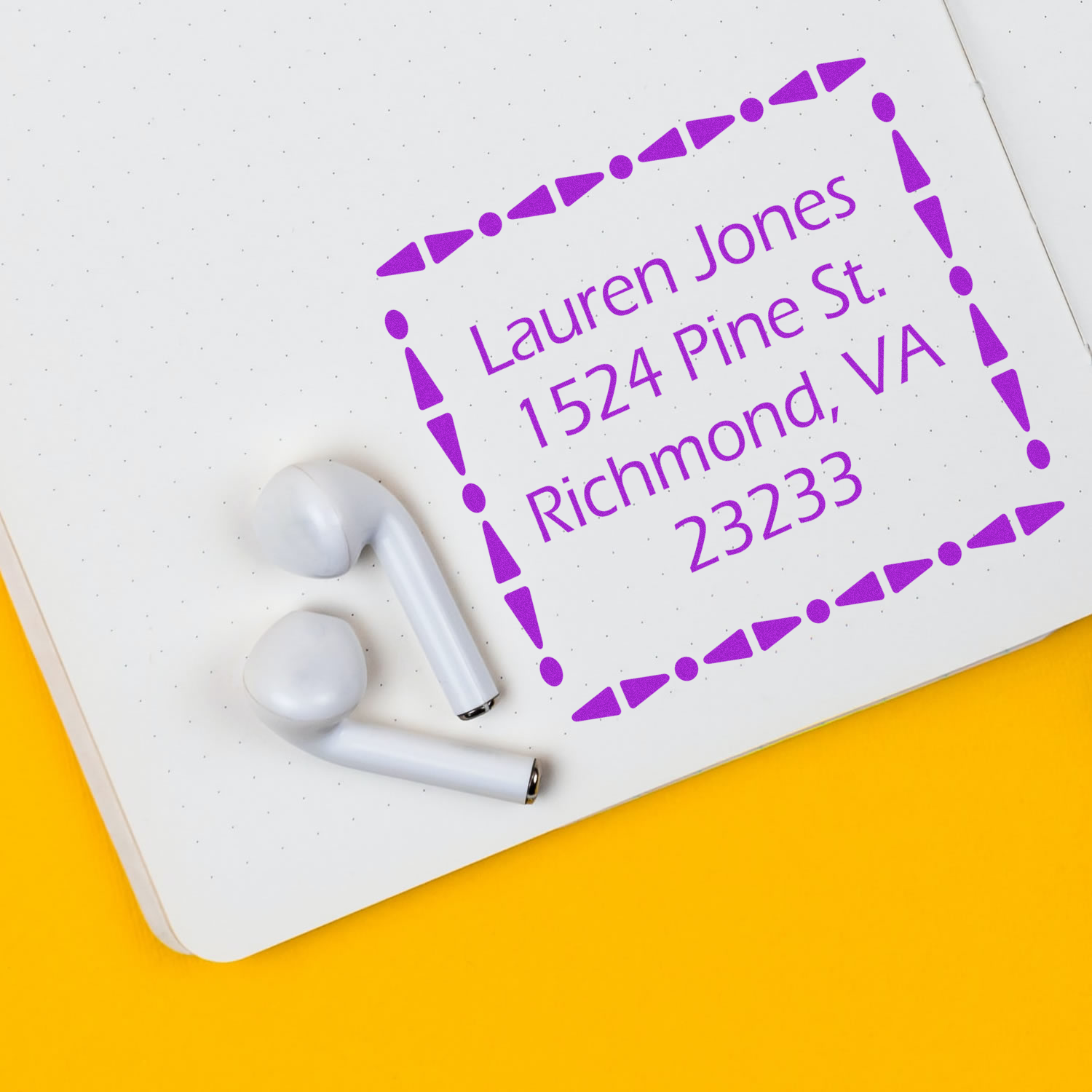 Personalized address rubber stamp impression with purple ink on notebook paper, showing Lauren Jones, Richmond, VA.