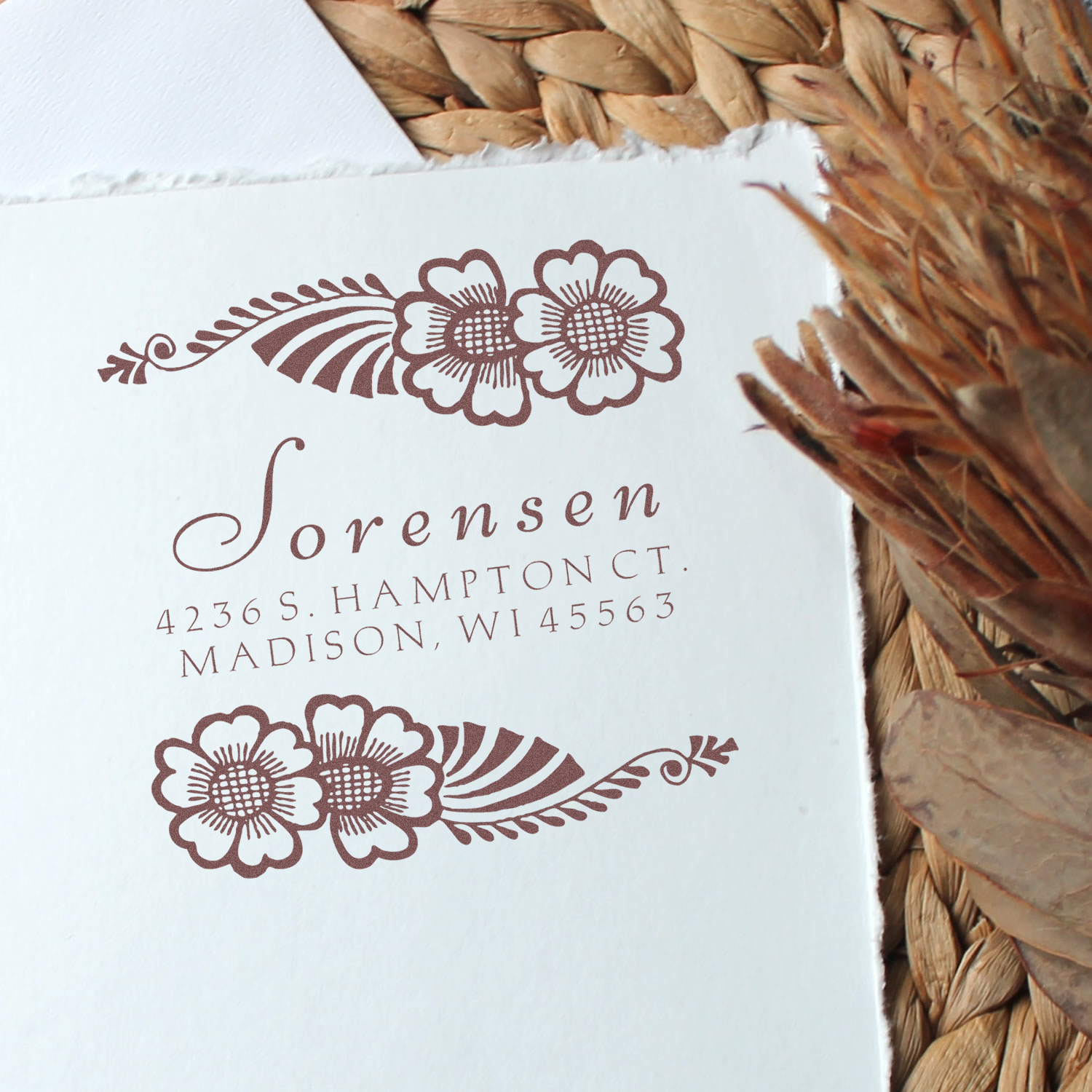 Custom floral return address rubber stamp with Lorensen name and address, perfect for wedding invitations and stationery.