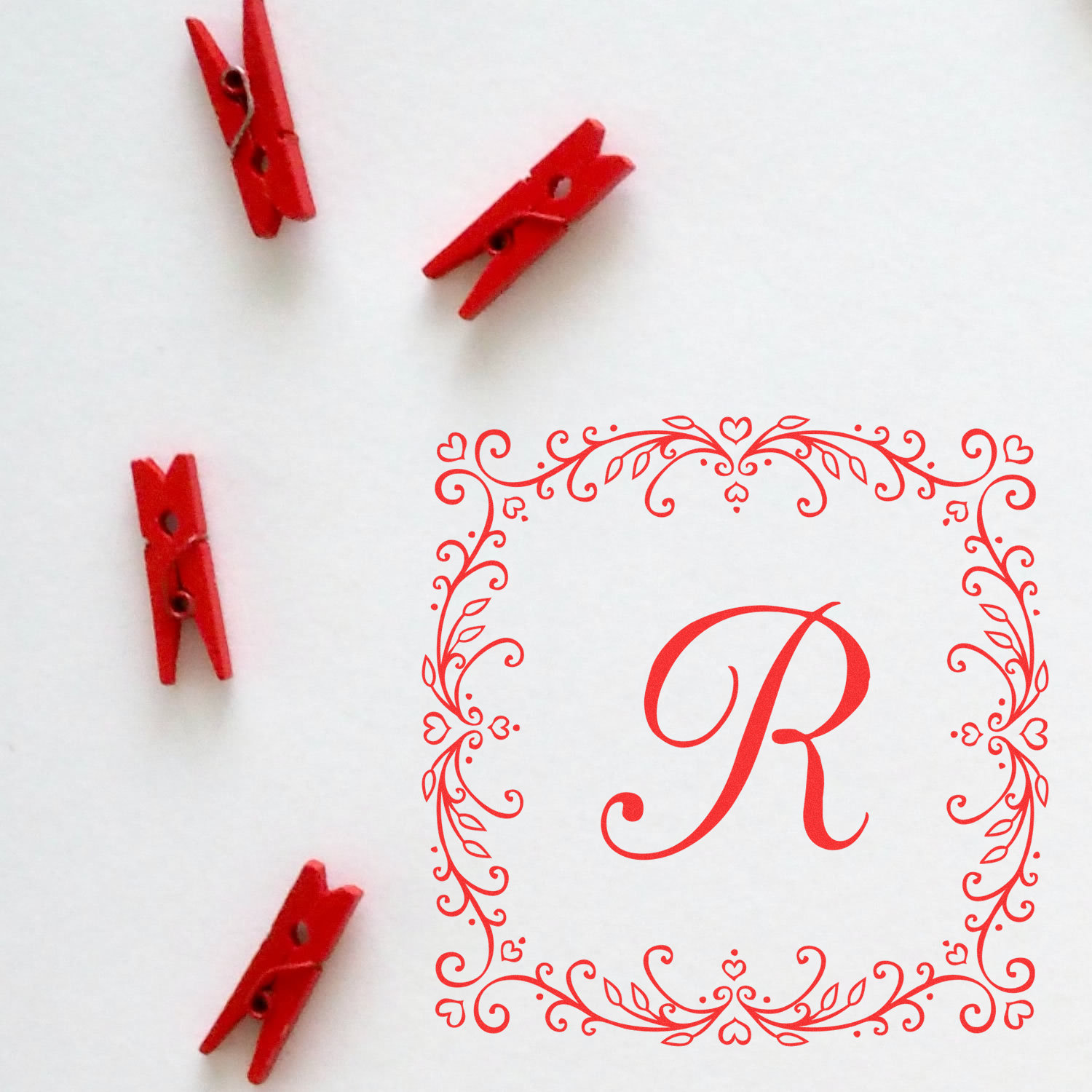 Custom monogram rubber stamp with ornate floral frame, ideal for personalized stationery, packaging, and craft branding.
