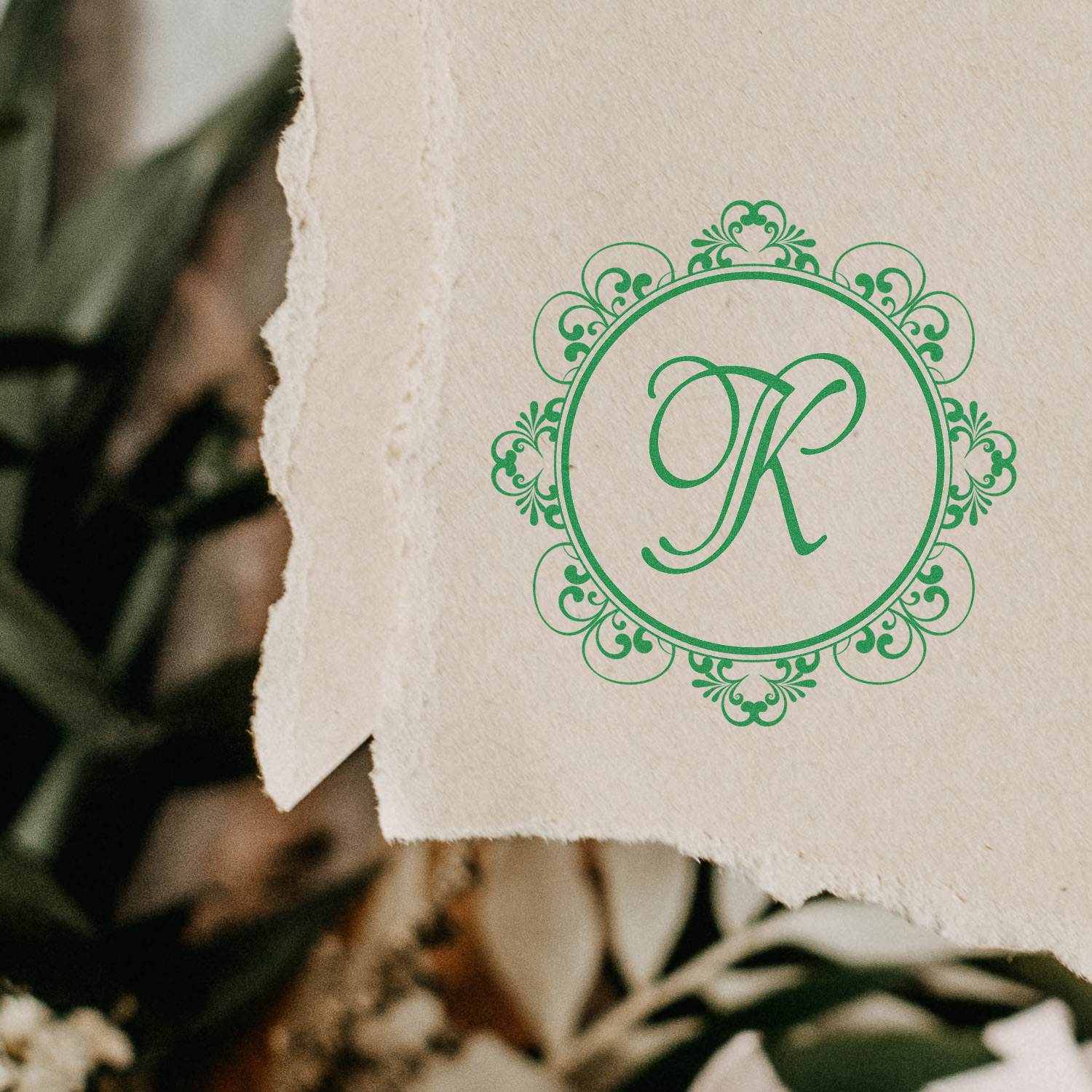 Elegant green monogram R rubber stamp design on textured paper for custom wedding invitations and stationery.