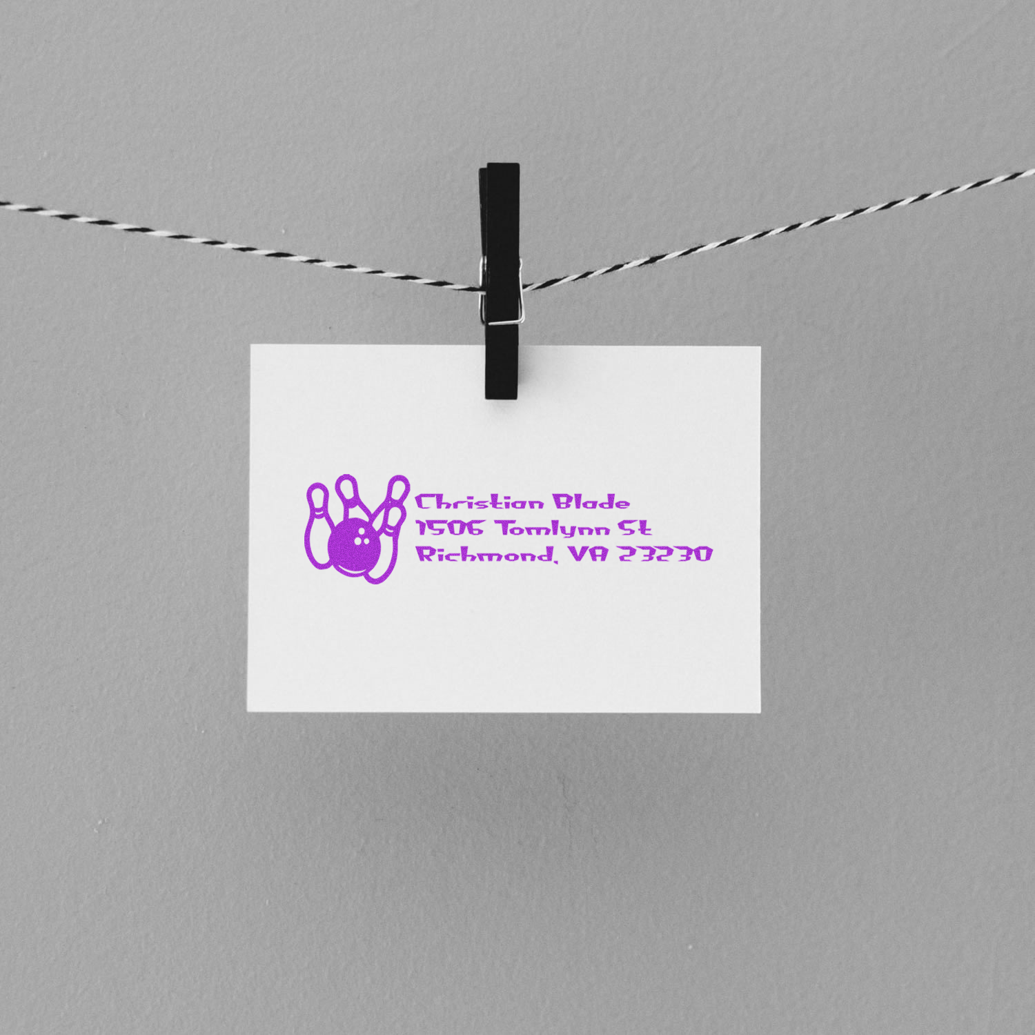 Custom return address rubber stamp with bowling pin logo, shown on a clipped card for personalized mail and stationery.