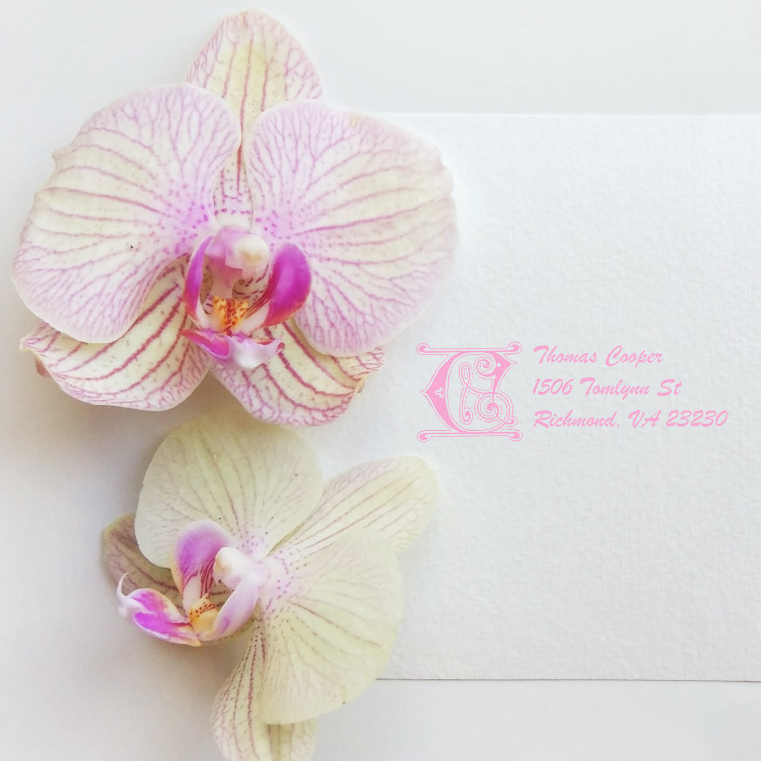 Pink custom orchid return address rubber stamp on white envelope with orchids.