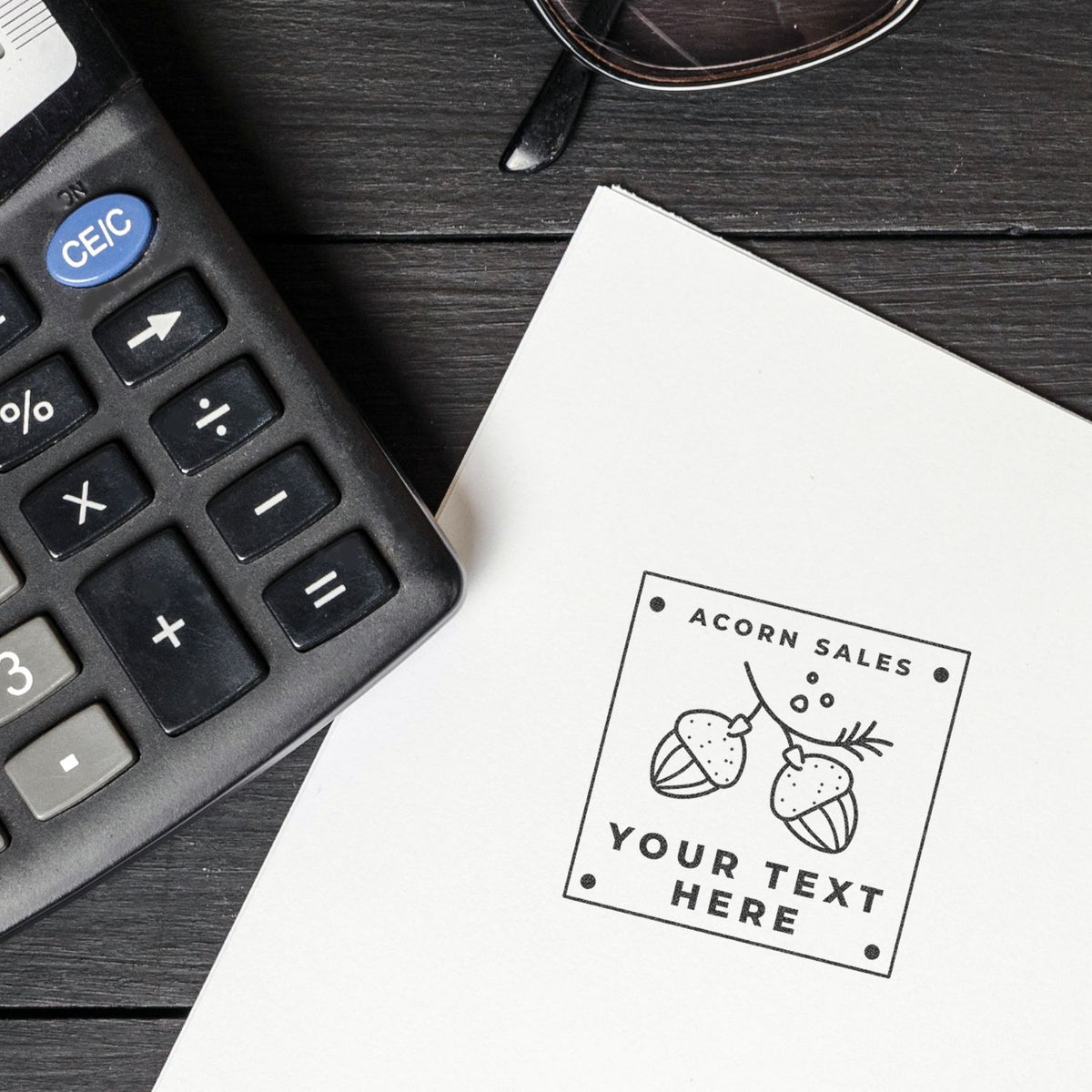 Calculator beside Acorn Sales label on paper, showing retail sales accounting and pricing calculations on a desk.