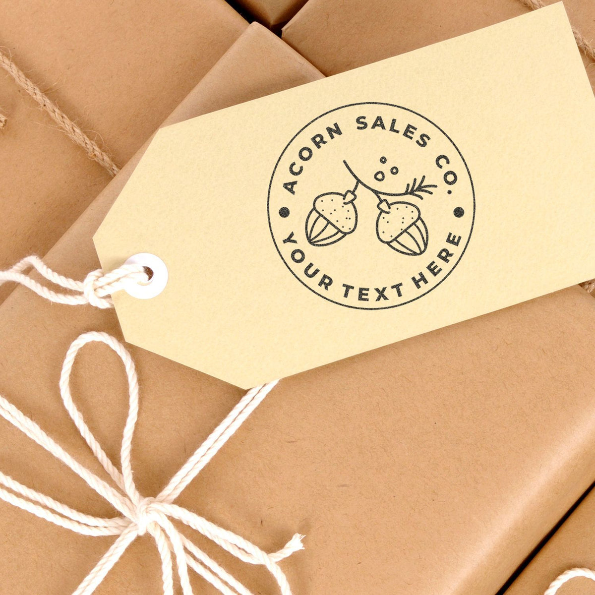 Kraft shipping boxes with custom circular ACORN SALES label and twine tie, promoting gift and product branding.