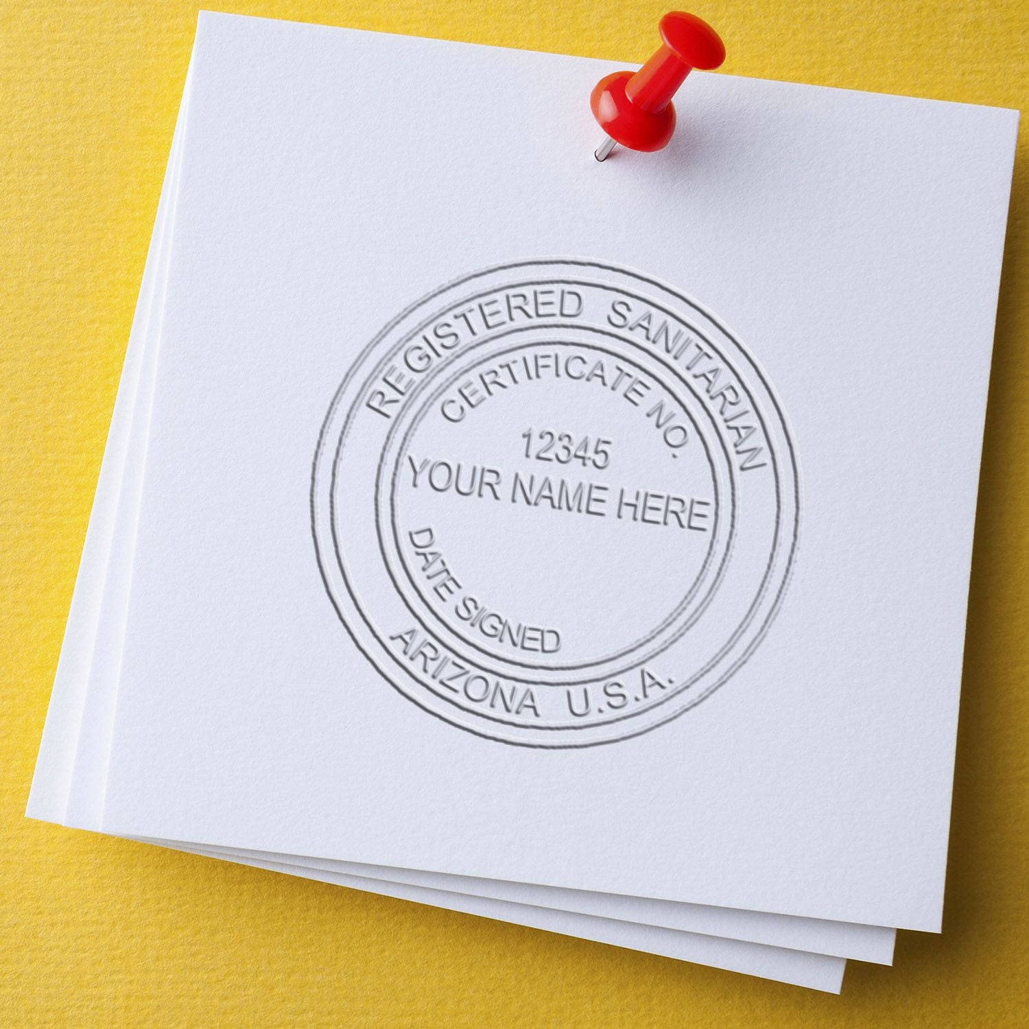 Registered Sanitarian certificate document with red pushpin on yellow background, Arizona USA.