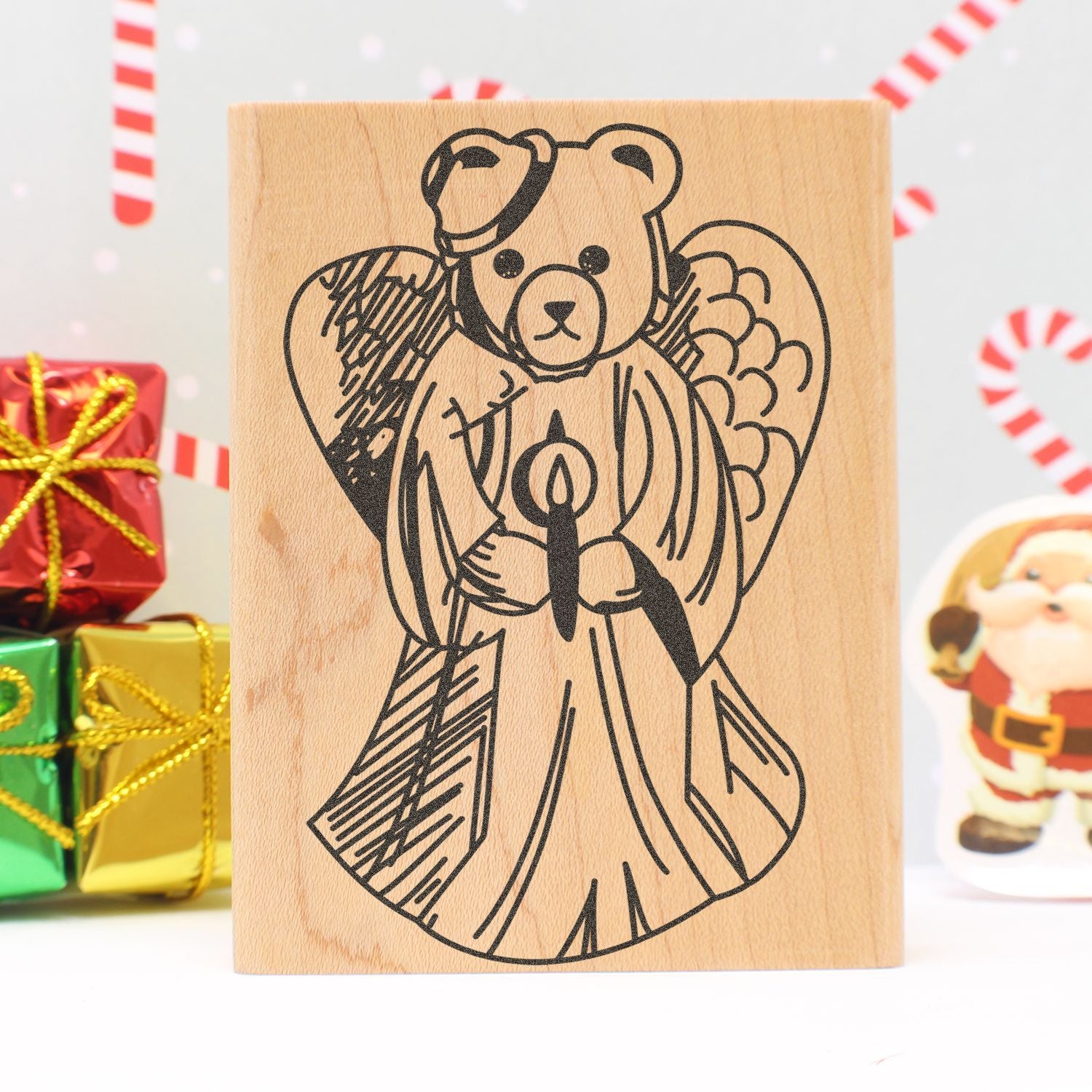 Wooden block with engraved teddy bear angel design, festive Christmas gift decor and Santa ornament background, holiday craft gift idea