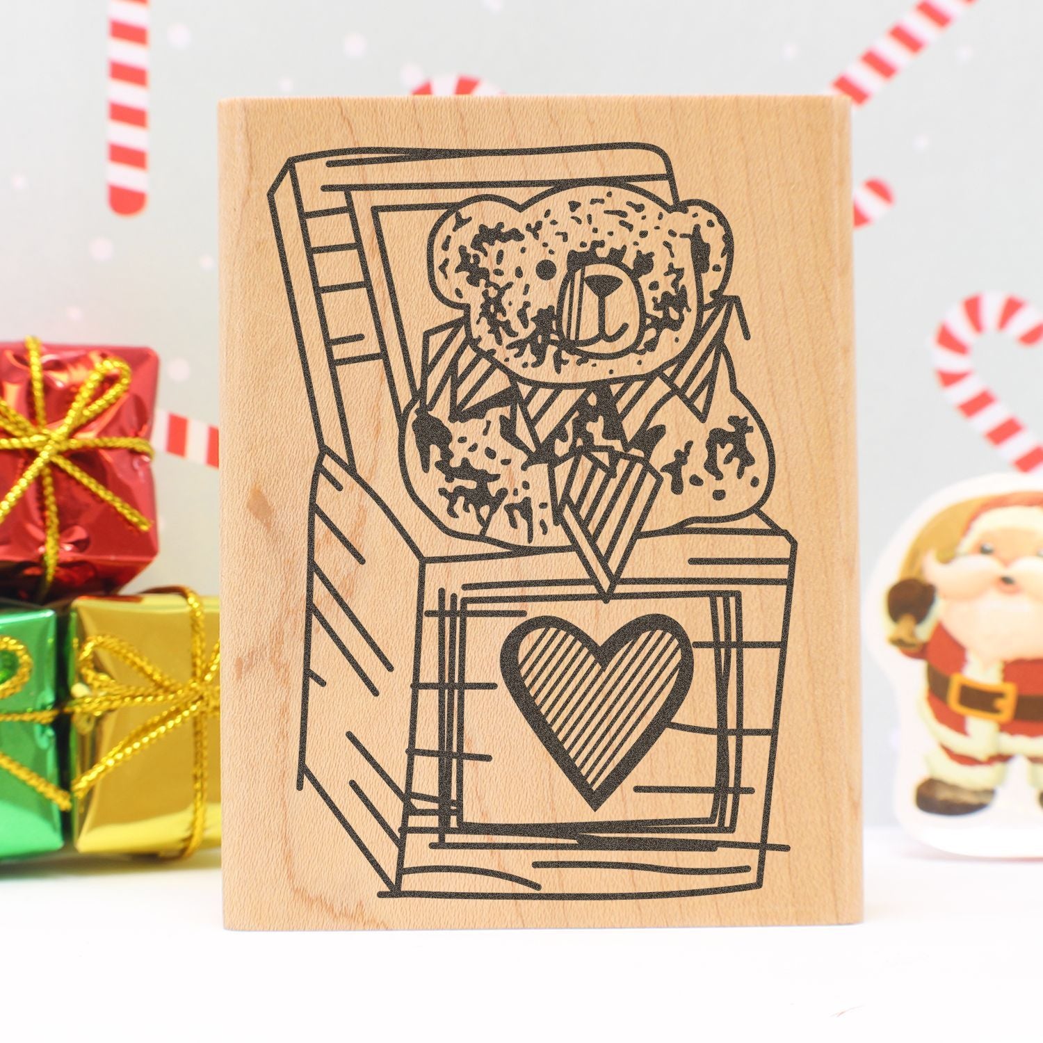 Christmas teddy bear gift box stamp design with festive presents and candy cane decorations