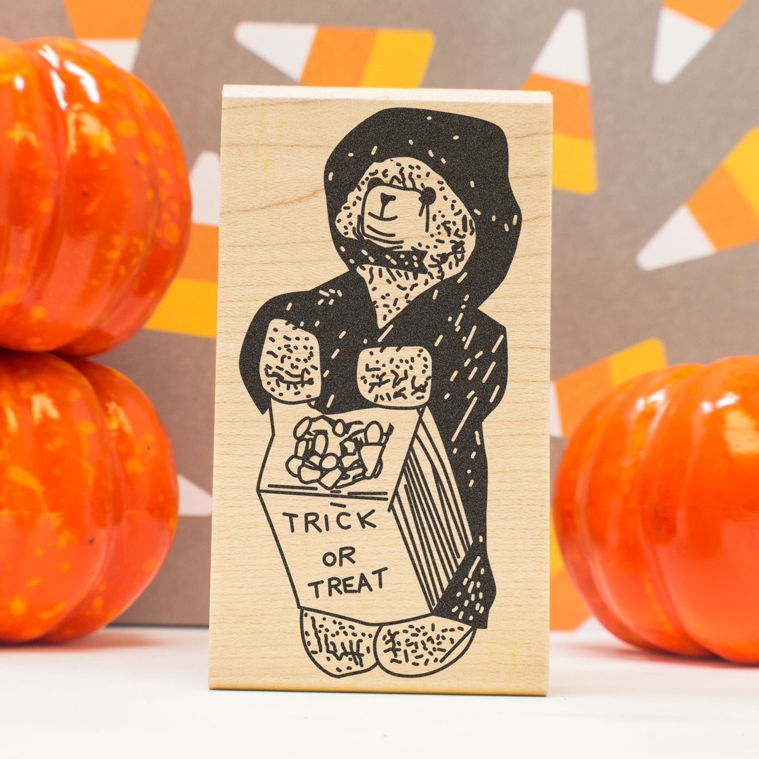 Halloween bear trick-or-treat wooden stamp block with pumpkins in the background