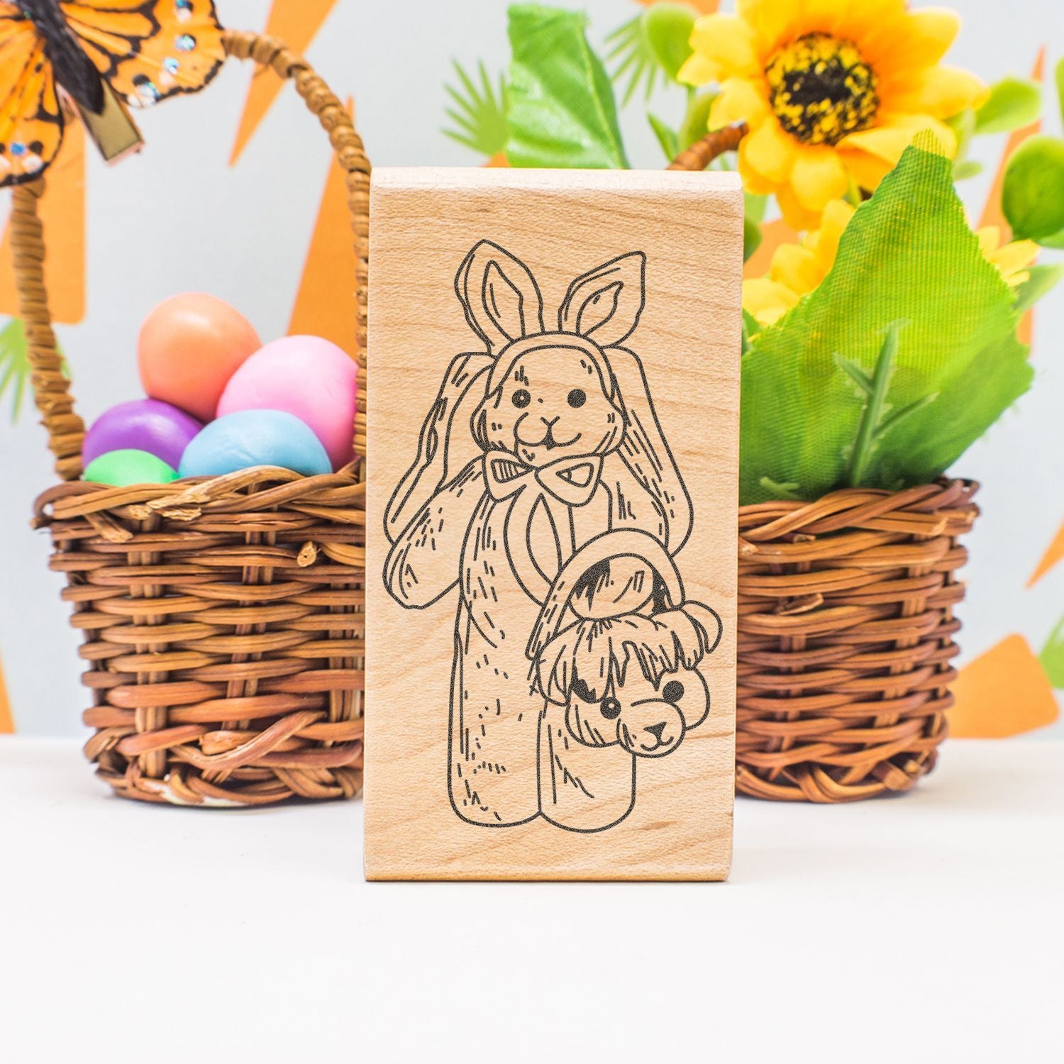 Wooden Easter bunny stamp with baskets of colorful eggs and spring floral decorations, cute holiday craft decor.