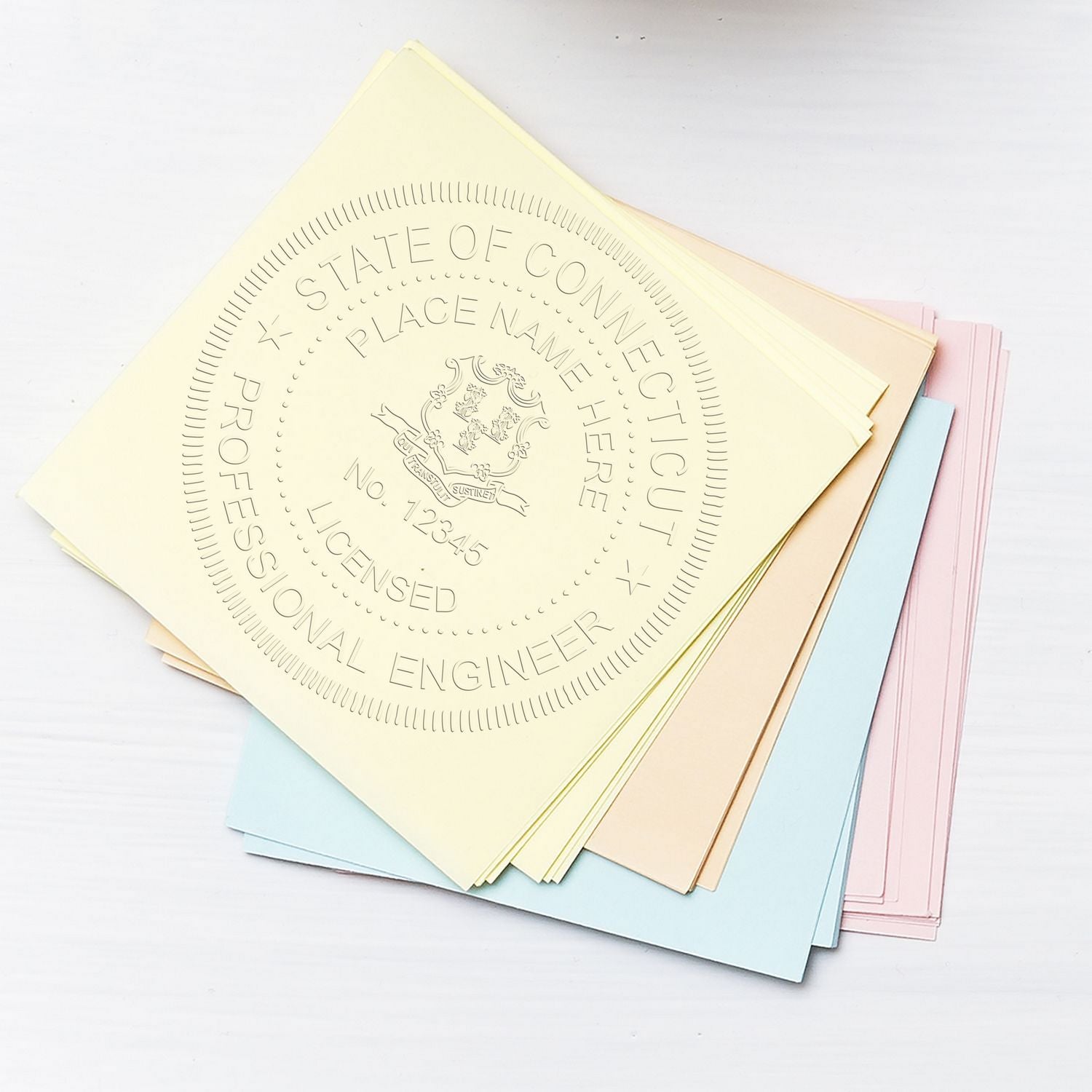 Pastel state professional engineer license folders stacked on white background