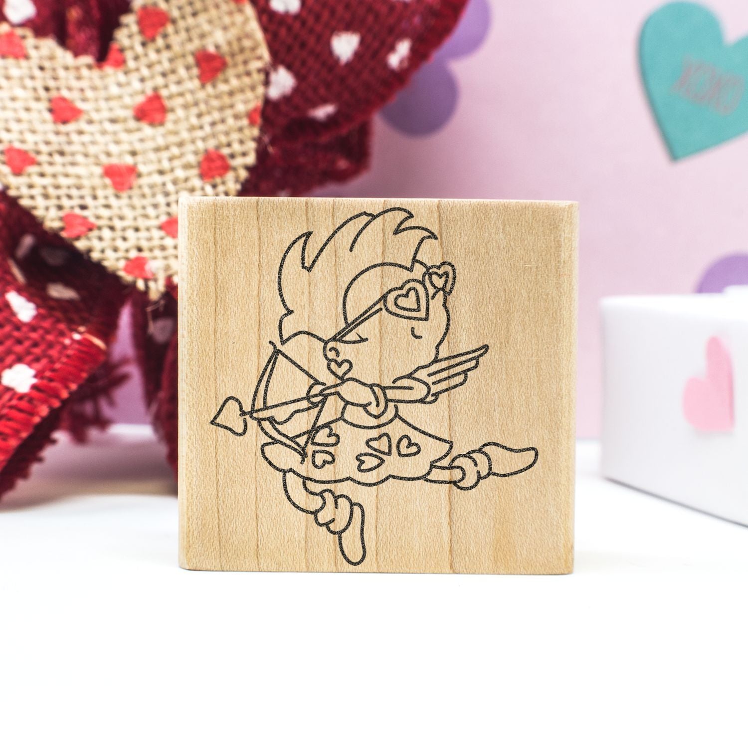 Wooden Cupid rubber stamp with heart design, perfect for Valentines Day crafts and DIY card making.