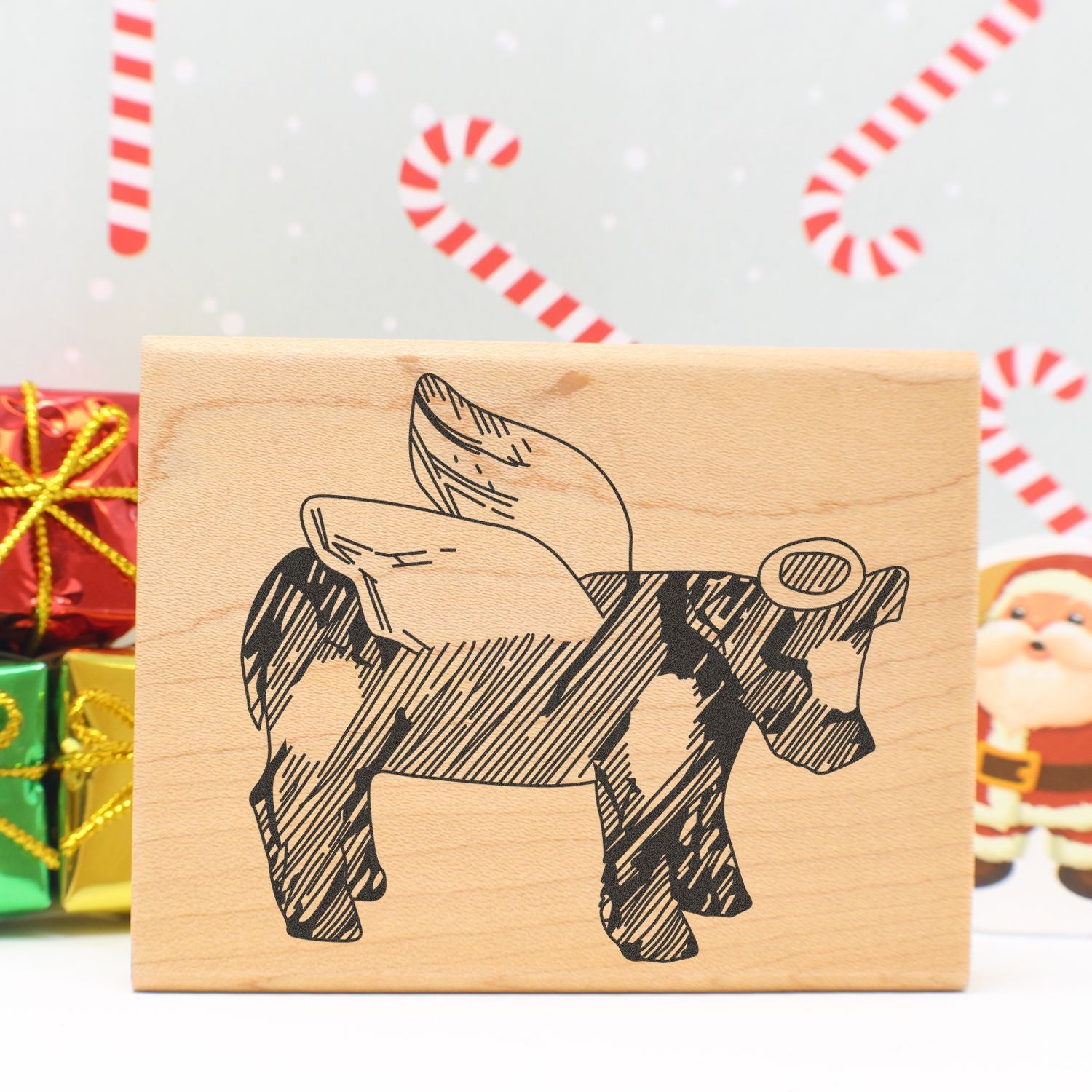 Wooden Christmas decor sign with a stylized donkey illustration, candy cane background, and festive holiday gifts.
