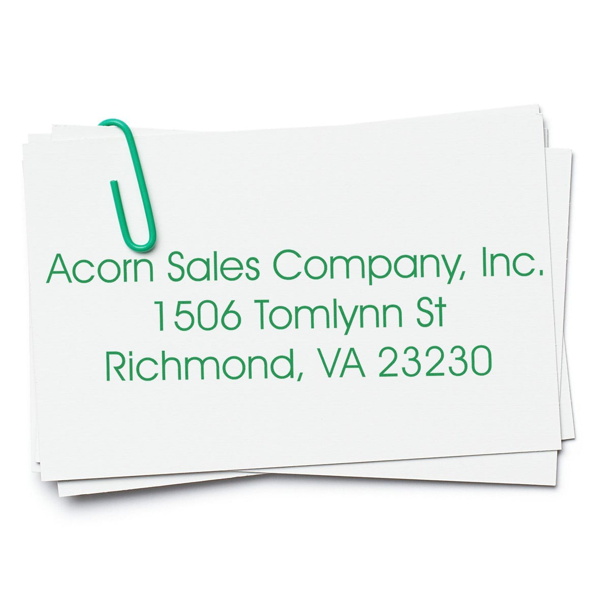 Custom business address rubber stamp for Acorn Sales Company, Inc., Richmond, VA 23230 on paper stack