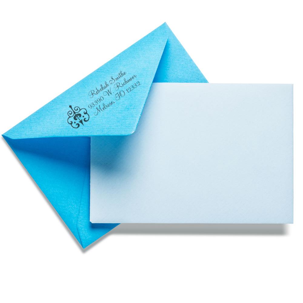 Custom rubber stamp return address on blue envelope with blank card for personalized wedding stationery.