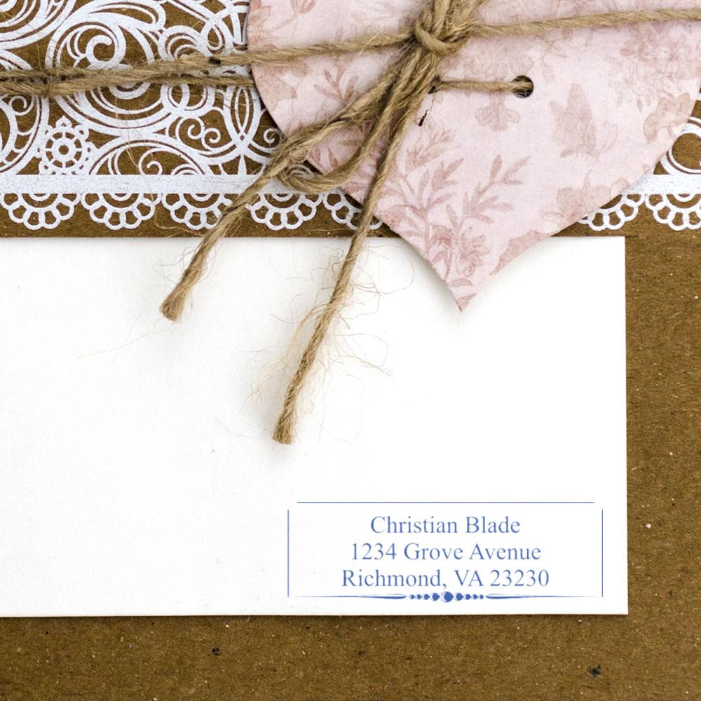 Personalized return address rubber stamp on envelope for wedding invitations and handmade stationery.