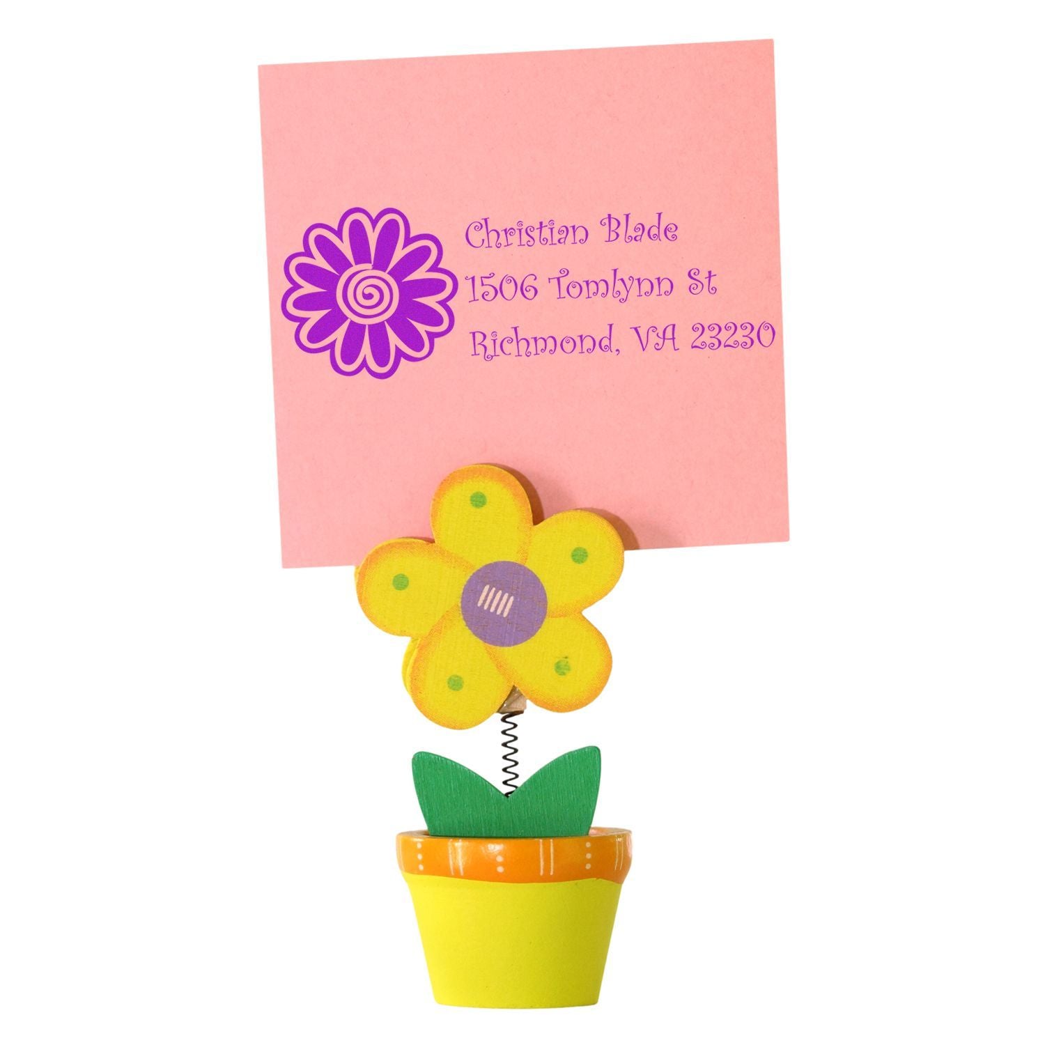 Purple flower return address rubber stamp on pink paper, shown with decorative flower clip, for personalized stationery and mailing.