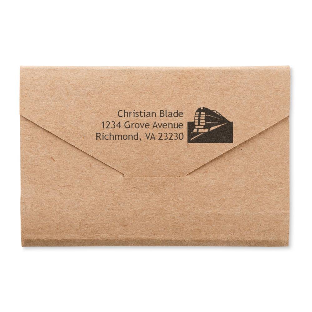 Custom return address rubber stamp on kraft envelope featuring name, street address and logo for personalized mailing.