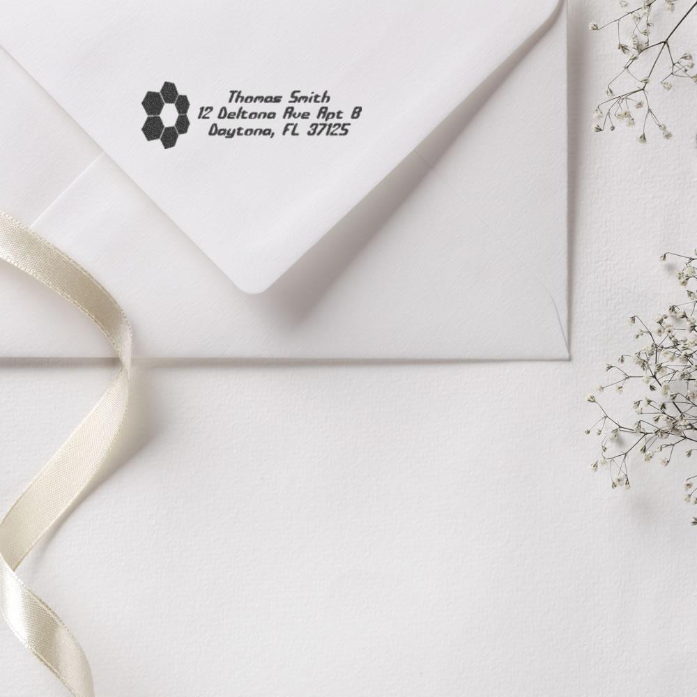 Custom address rubber stamp on white envelope with logo, featuring Thomas Smith name and Daytona, FL address.