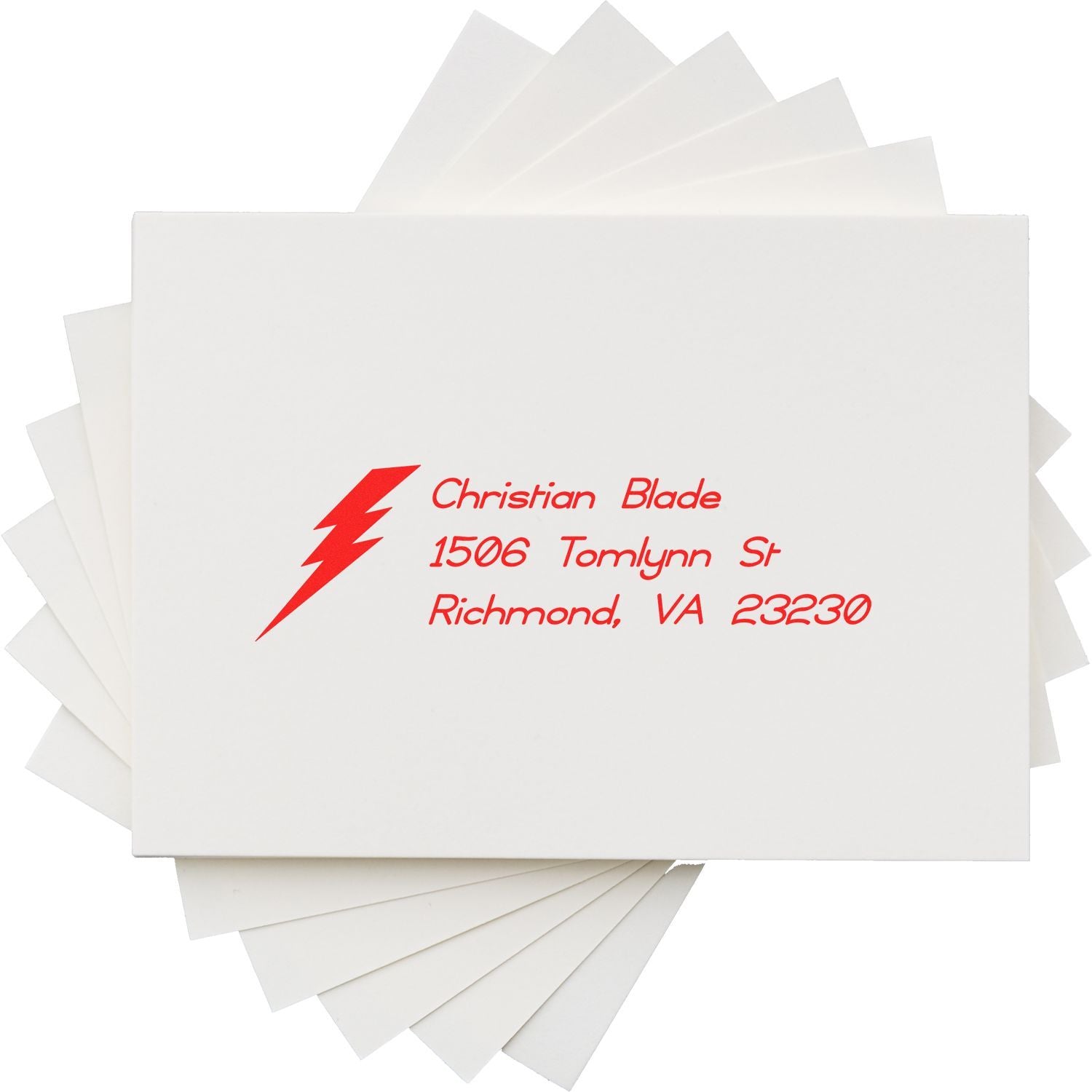 Custom return address rubber stamp with lightning bolt logo for Christian Blade, Richmond, VA on white envelopes.