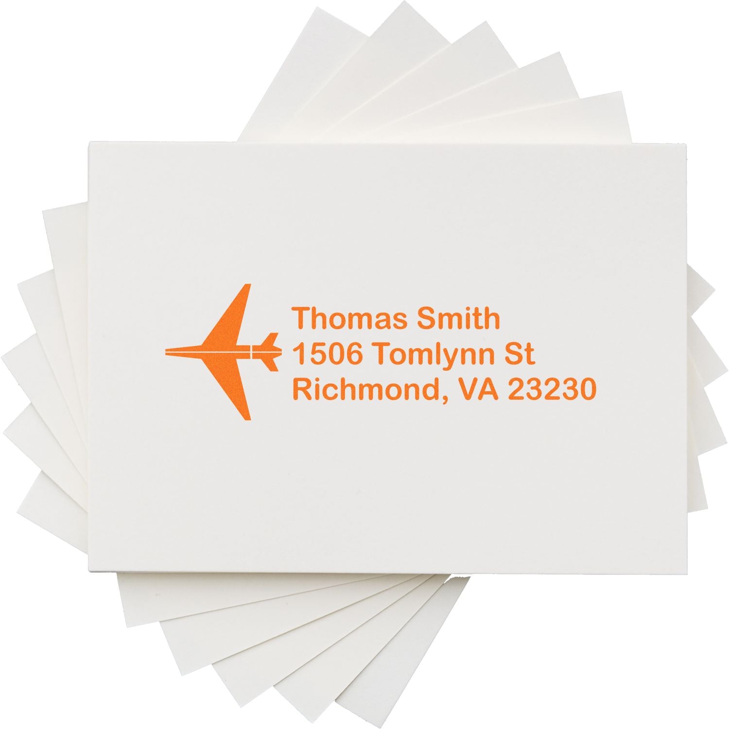 Personalized return address rubber stamp with airplane logo and orange ink on white envelopes