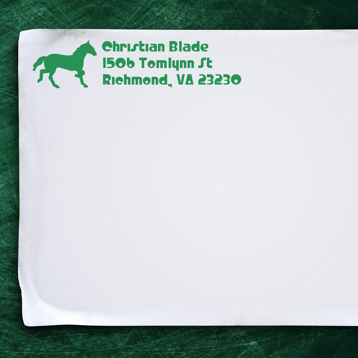 Green custom horse logo address rubber stamp on envelope for Christian Blade, Richmond, VA 23230.