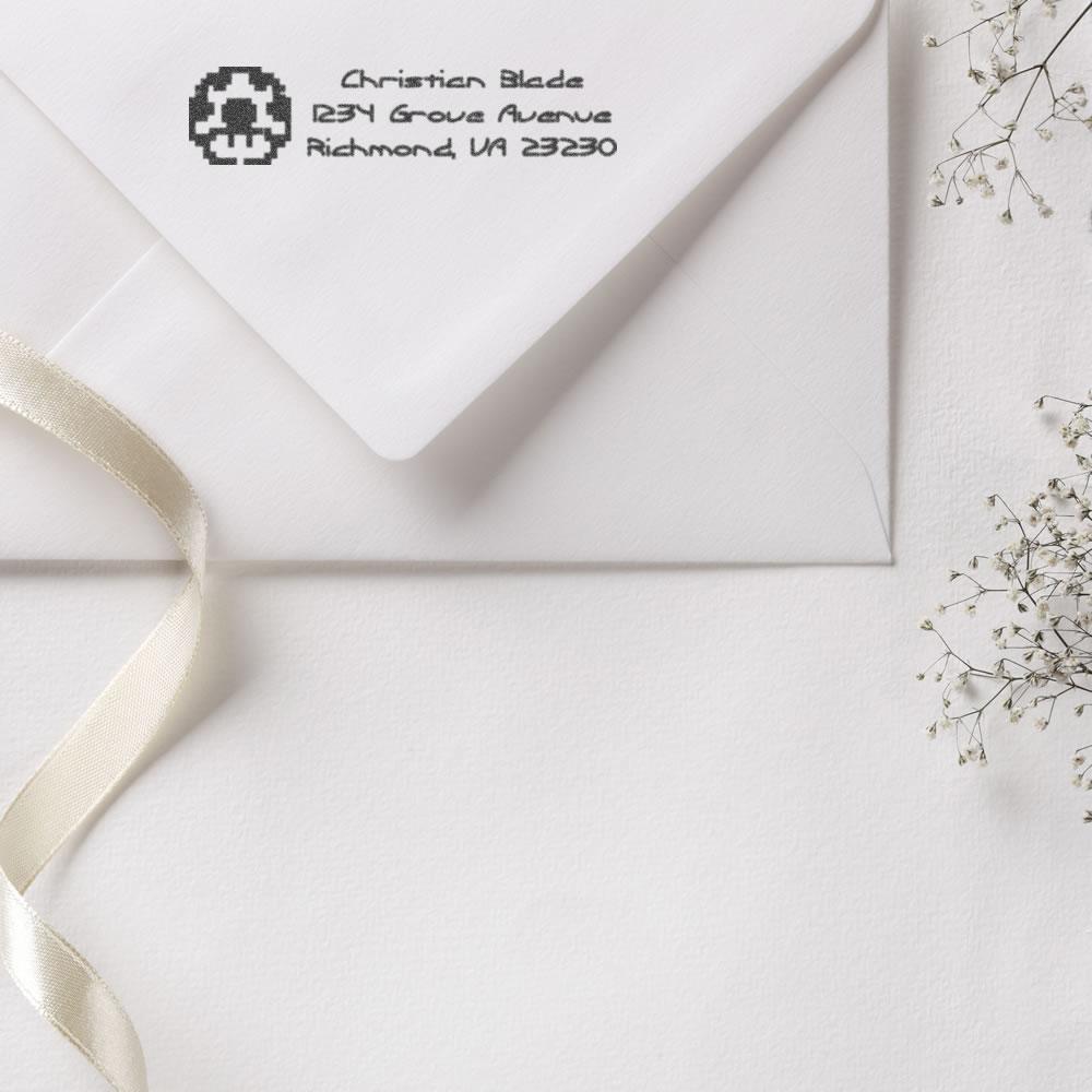 Personalized rubber address stamp on white envelope, perfect for elegant wedding invitations and mailing.