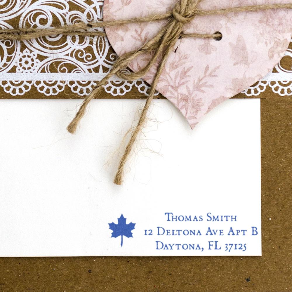 Personalized return address rubber stamp with maple leaf design on wedding invitation card, blue ink imprint
