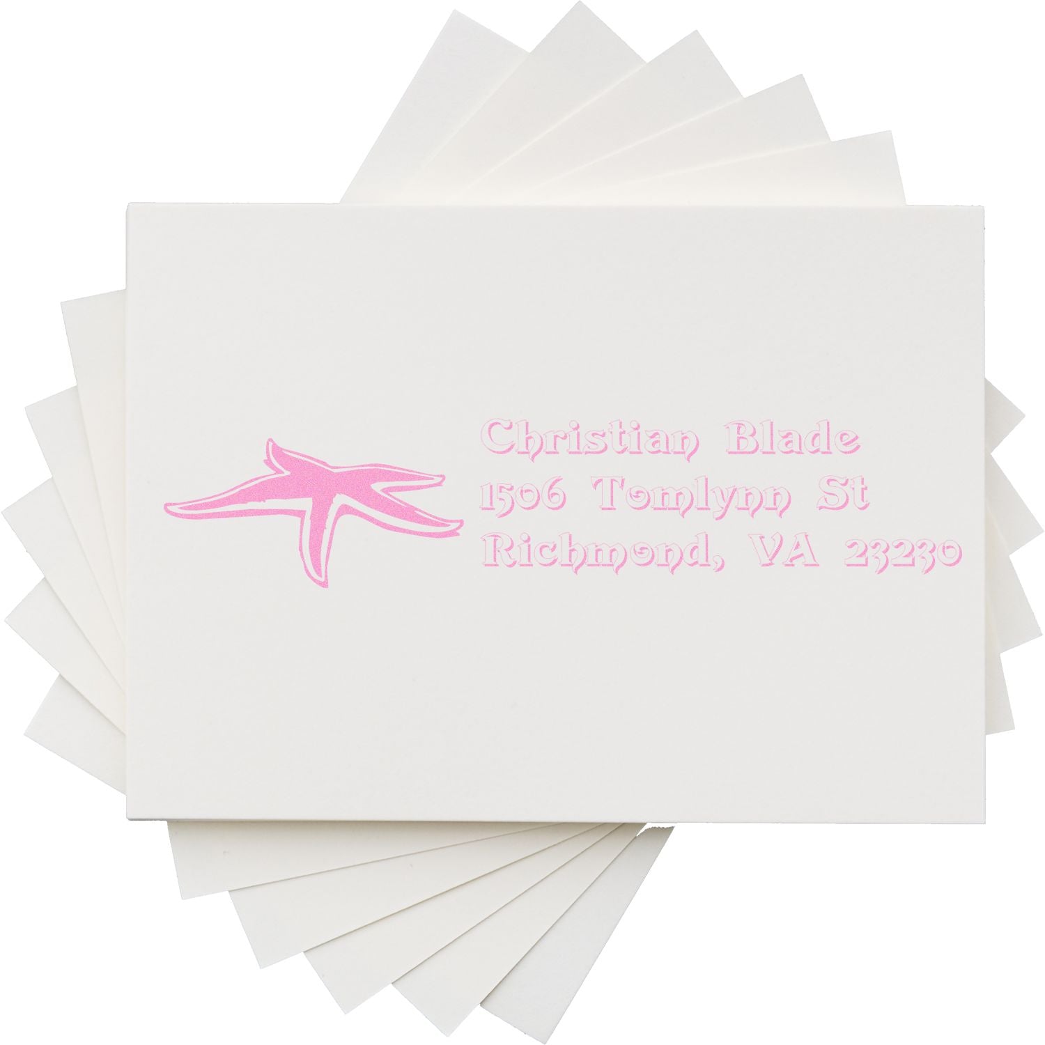 Custom rubber stamp impression with pink logo and return address, showcasing a personalized address stamp design.