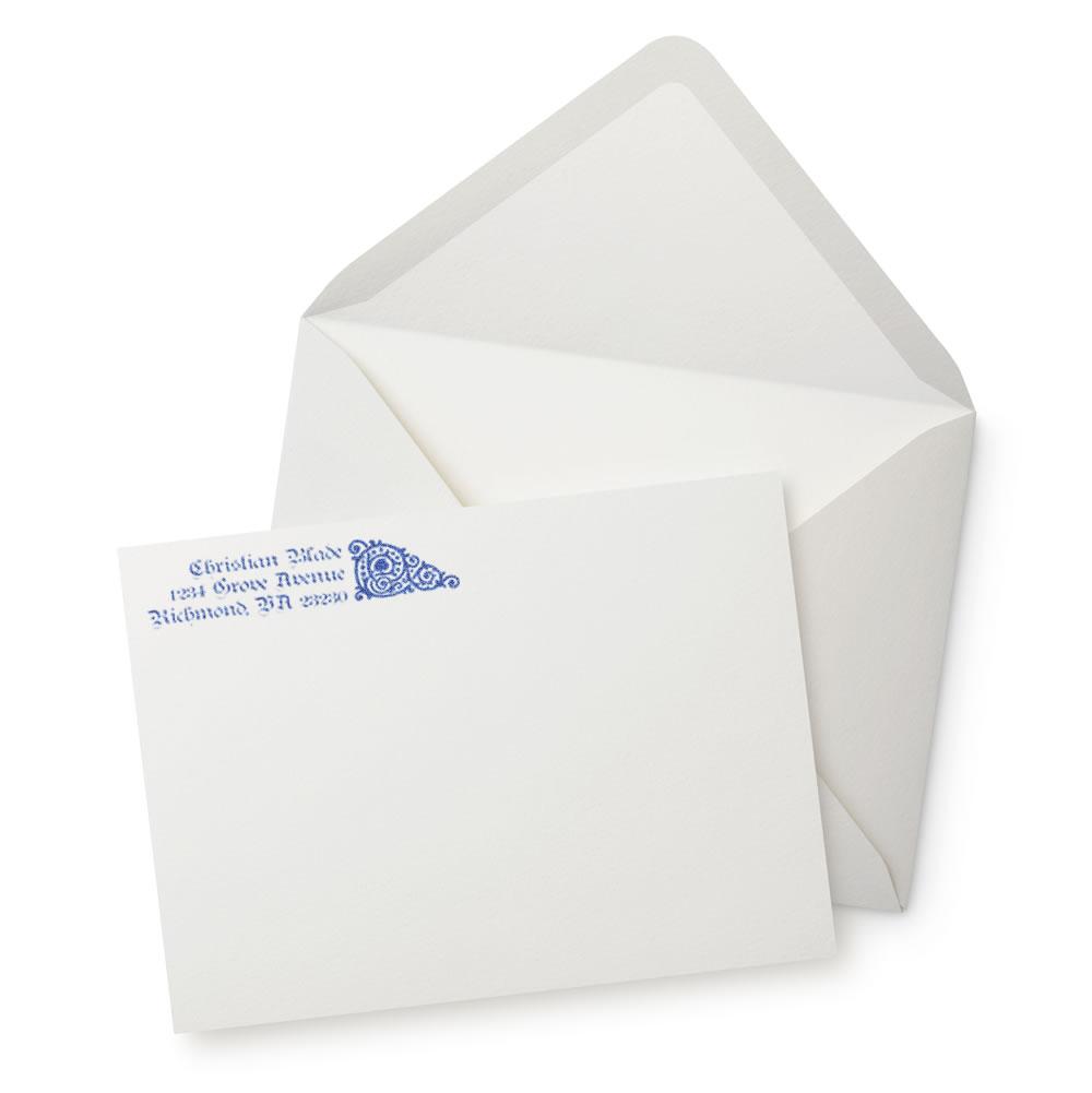 Custom return address rubber stamp on envelope and stationery, with blue address imprint for wedding invitations and mailings.