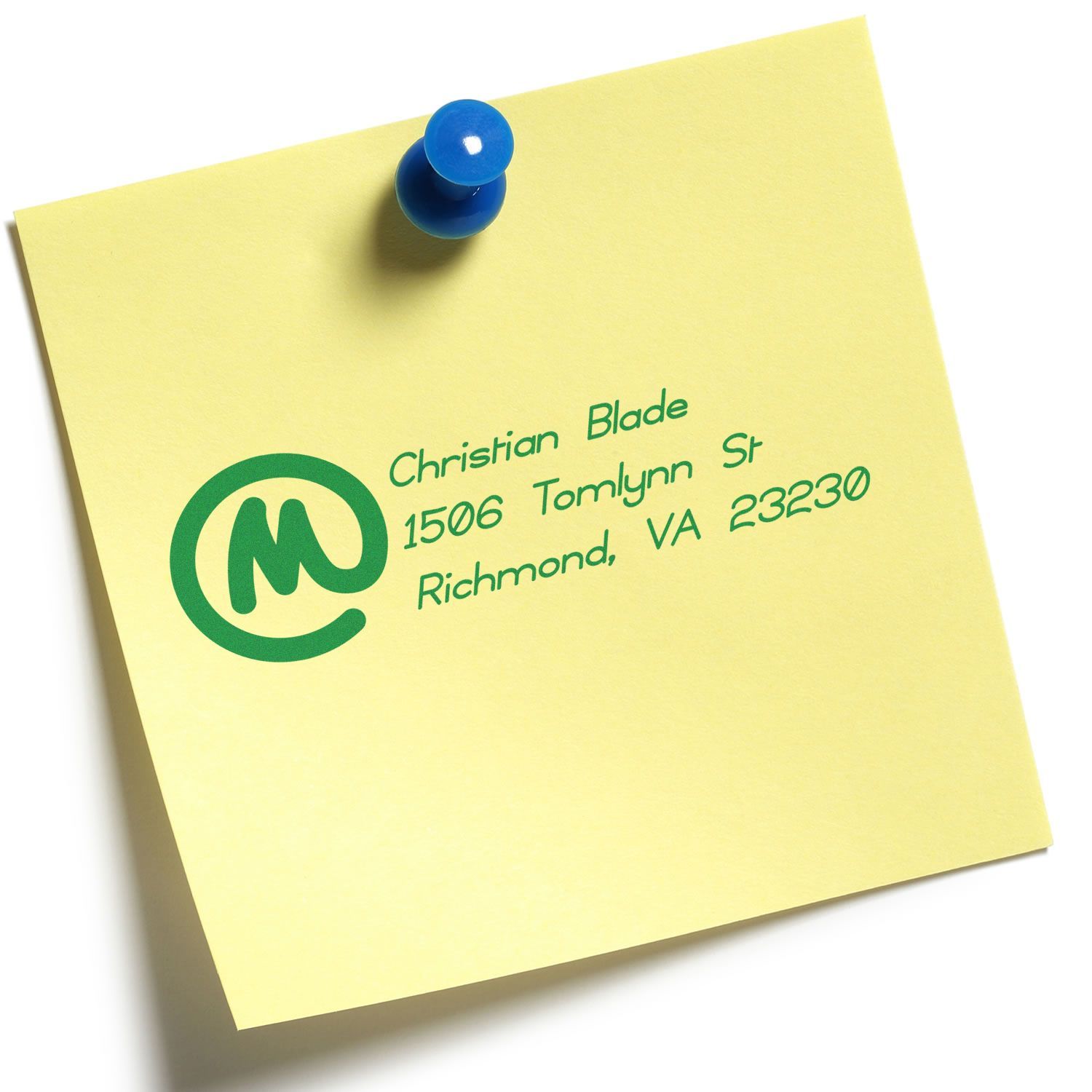 Custom address rubber stamp on a sticky note, showing a green return address imprint for business mailing.