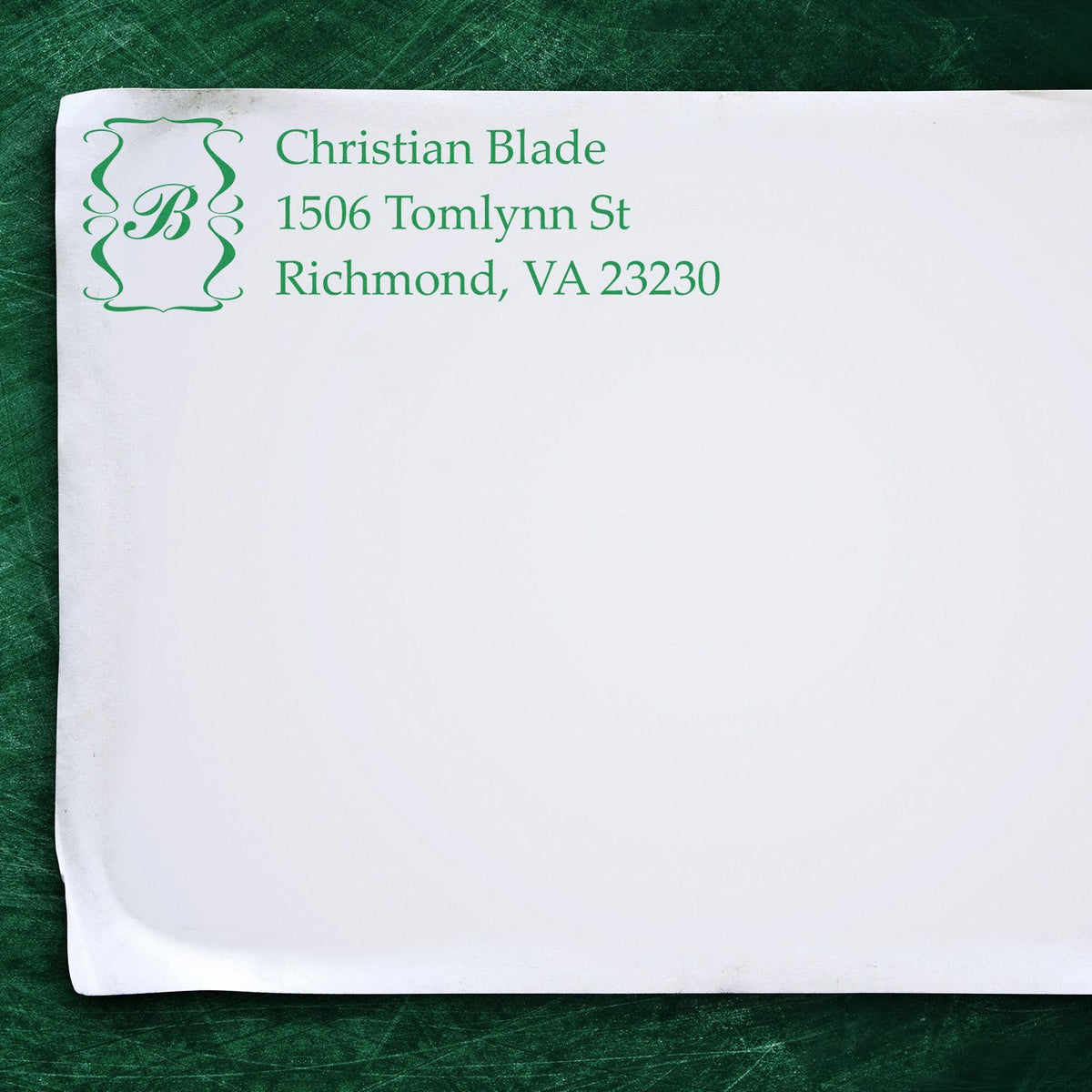 Custom return address rubber stamp with monogram, name, and Richmond, VA address in green ink on paper.