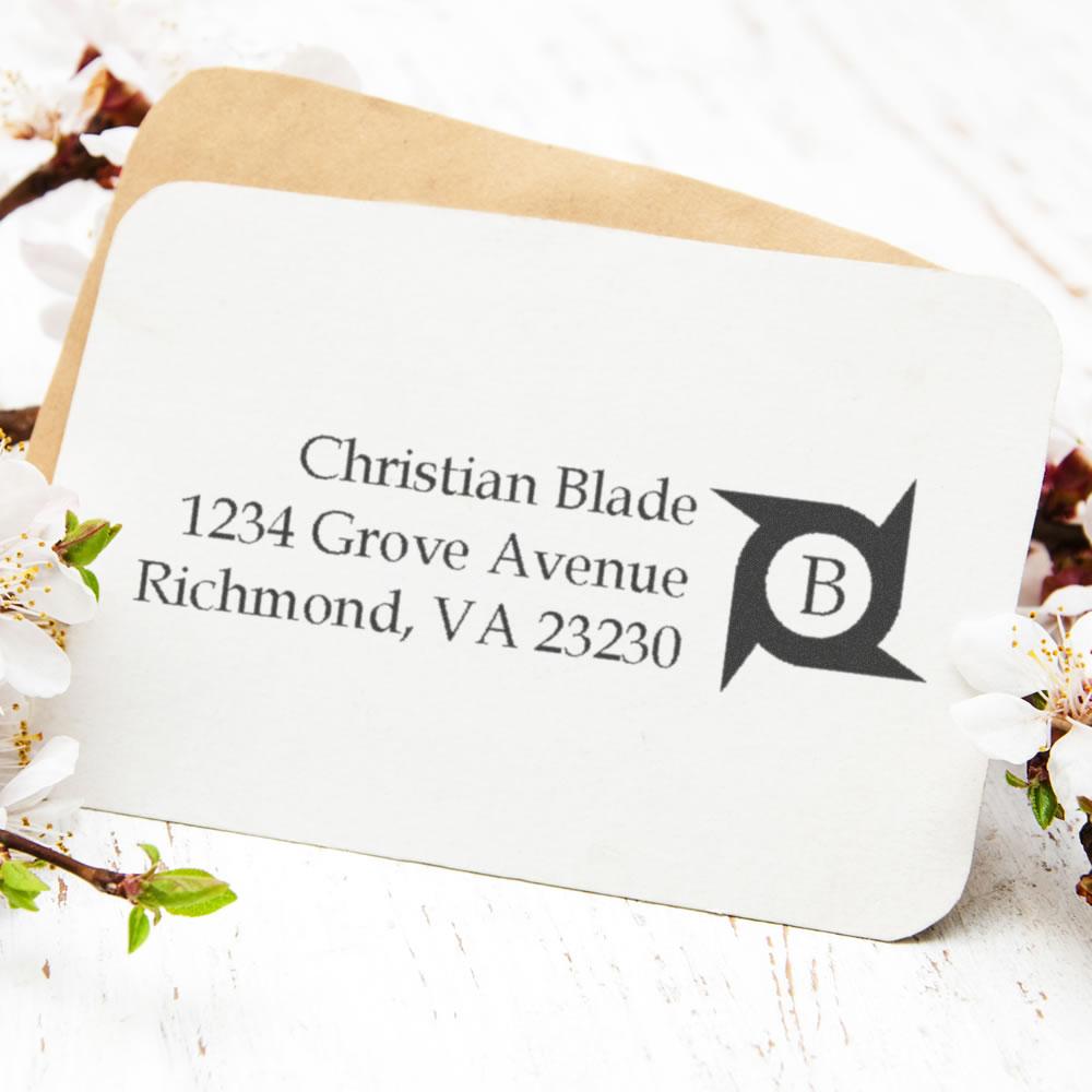 Custom address rubber stamp imprint on envelope, showing name, street address and monogram logo.