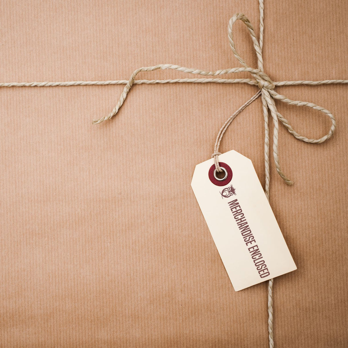 Merchandising equipment price tag on white label tied with twine on a rustic wooden background