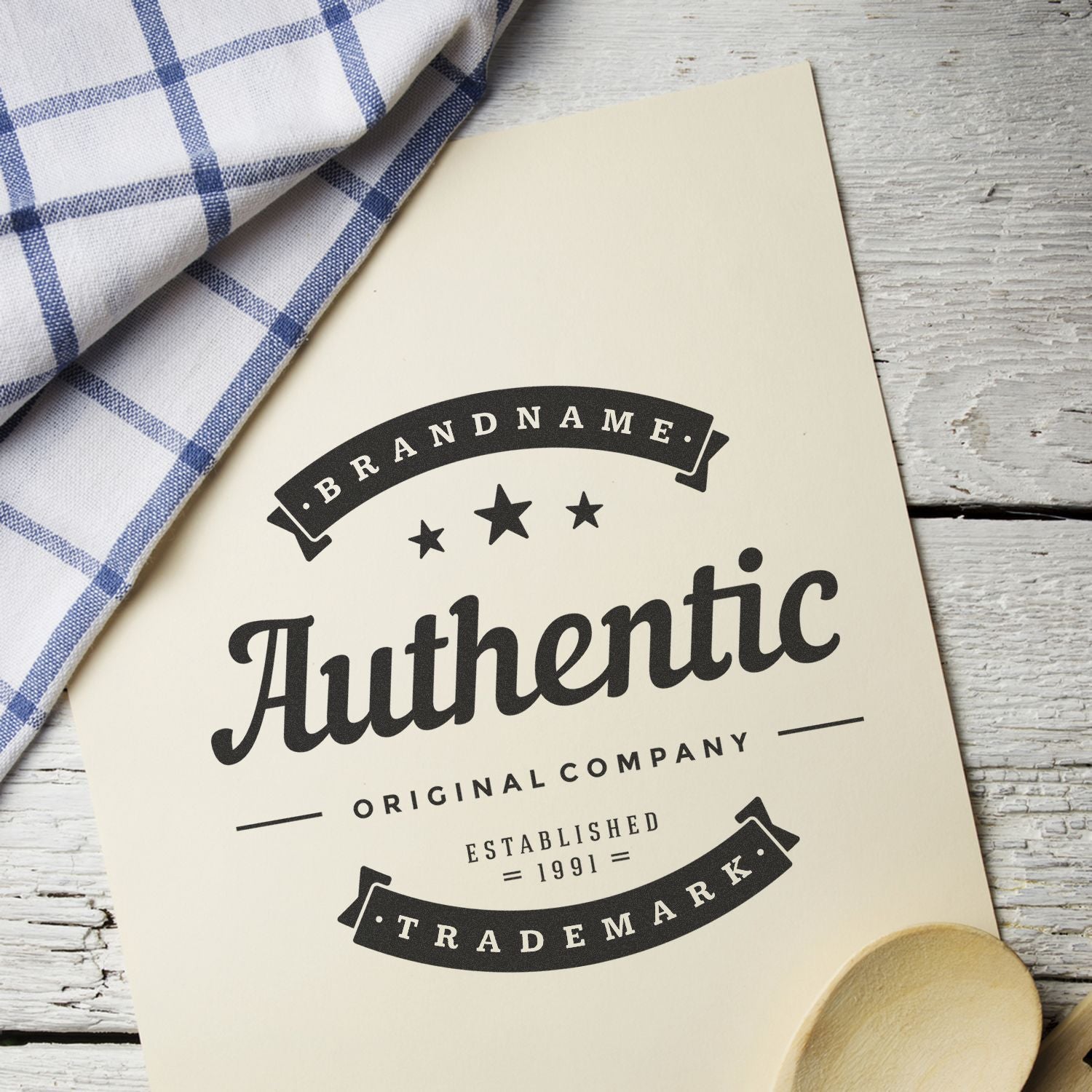 Huthentic brand logo on packaging with 1991 established text, styled on rustic wood with blue checkered cloth.
