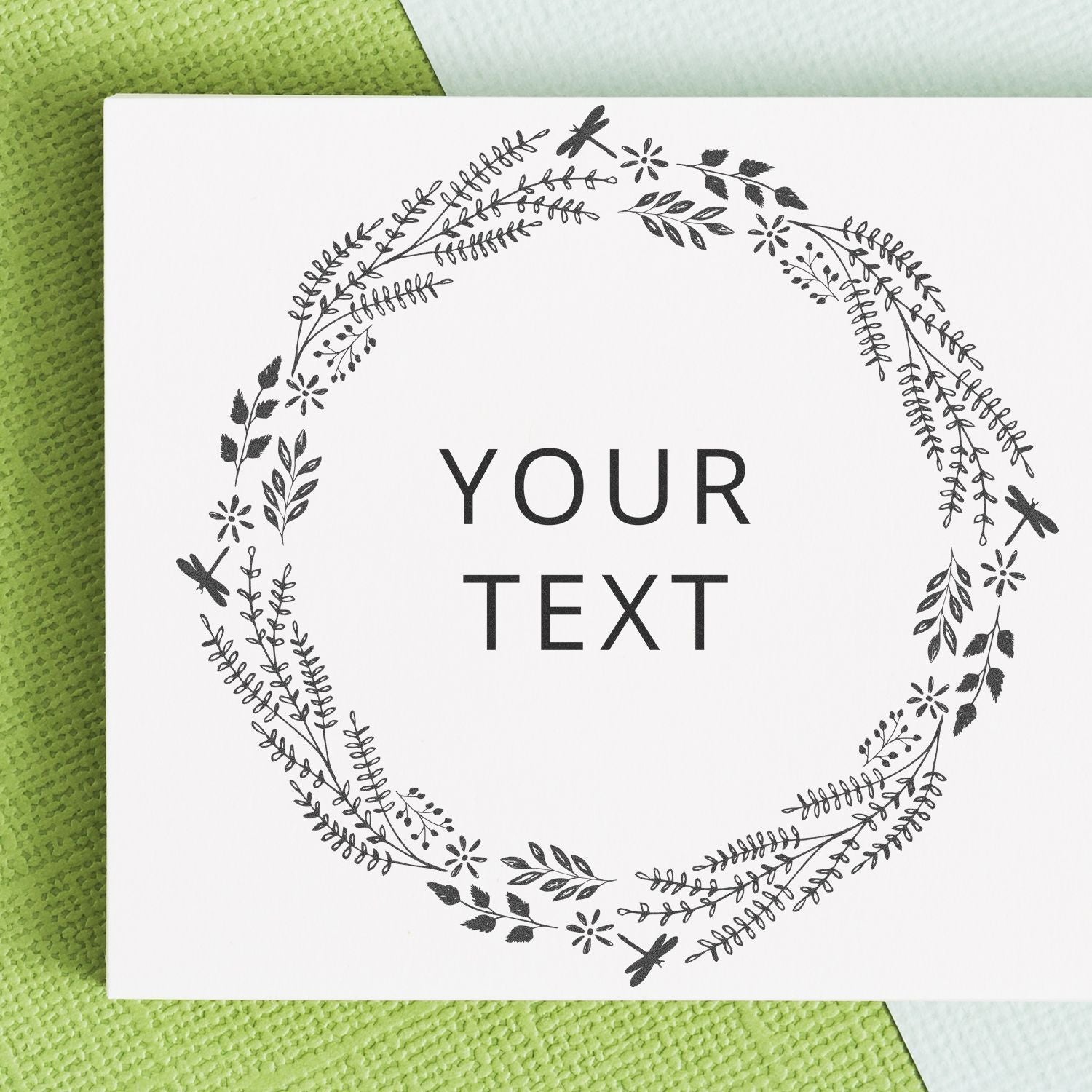 Personalized greeting card with floral botanical wreath border, blank text area reading YOUR TEXT, for invitations and notes.