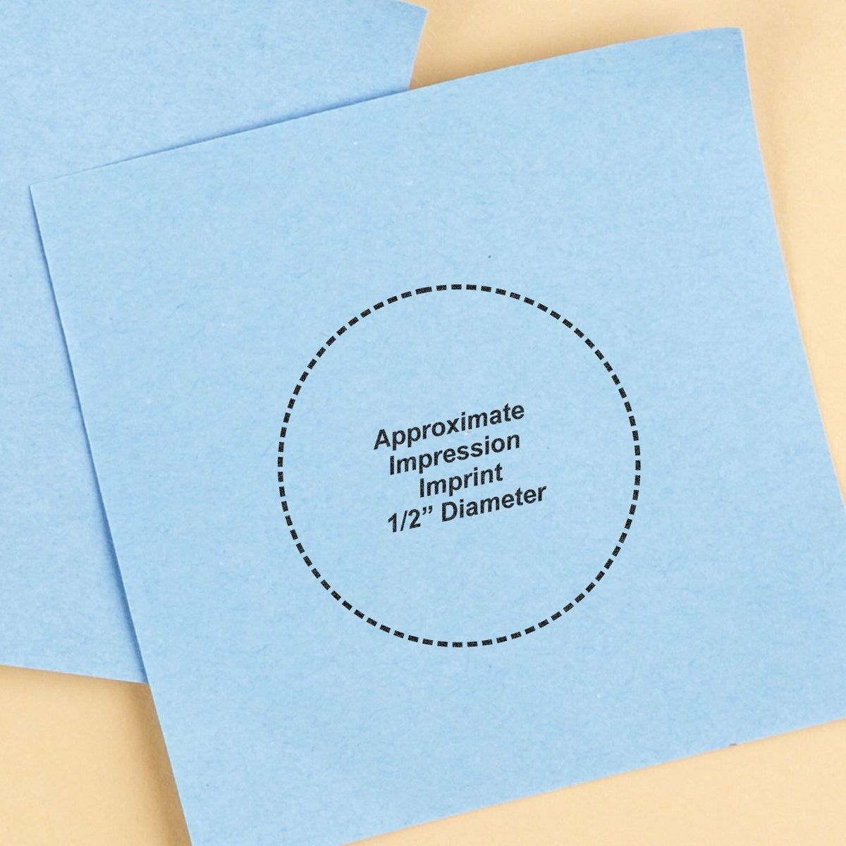 Blue dental impression material sample with 1/2-inch diameter imprint circle on a beige background
