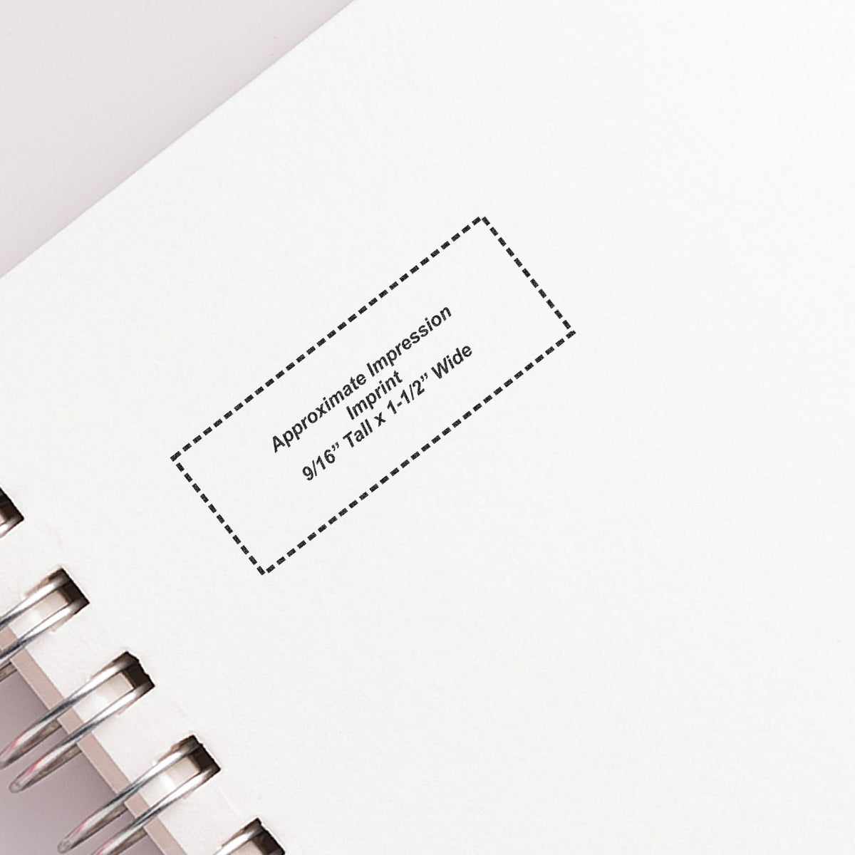 Blank spiral notebook page with approximate impression print area and dashed template box for custom design mockup.