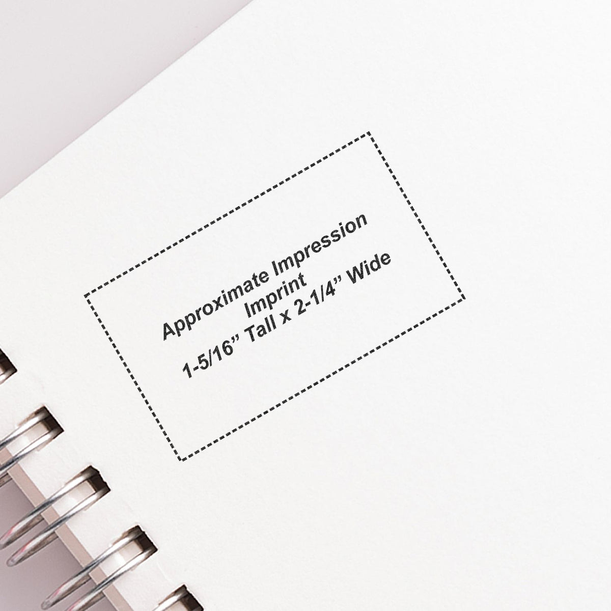Close-up of spiral notebook imprint template with approximate 1-5/16 inch tall by 2-1/4 inch wide print area.